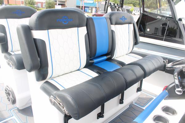 2024 Fountain 34 SC boat interior with black and white seating, blue accents.