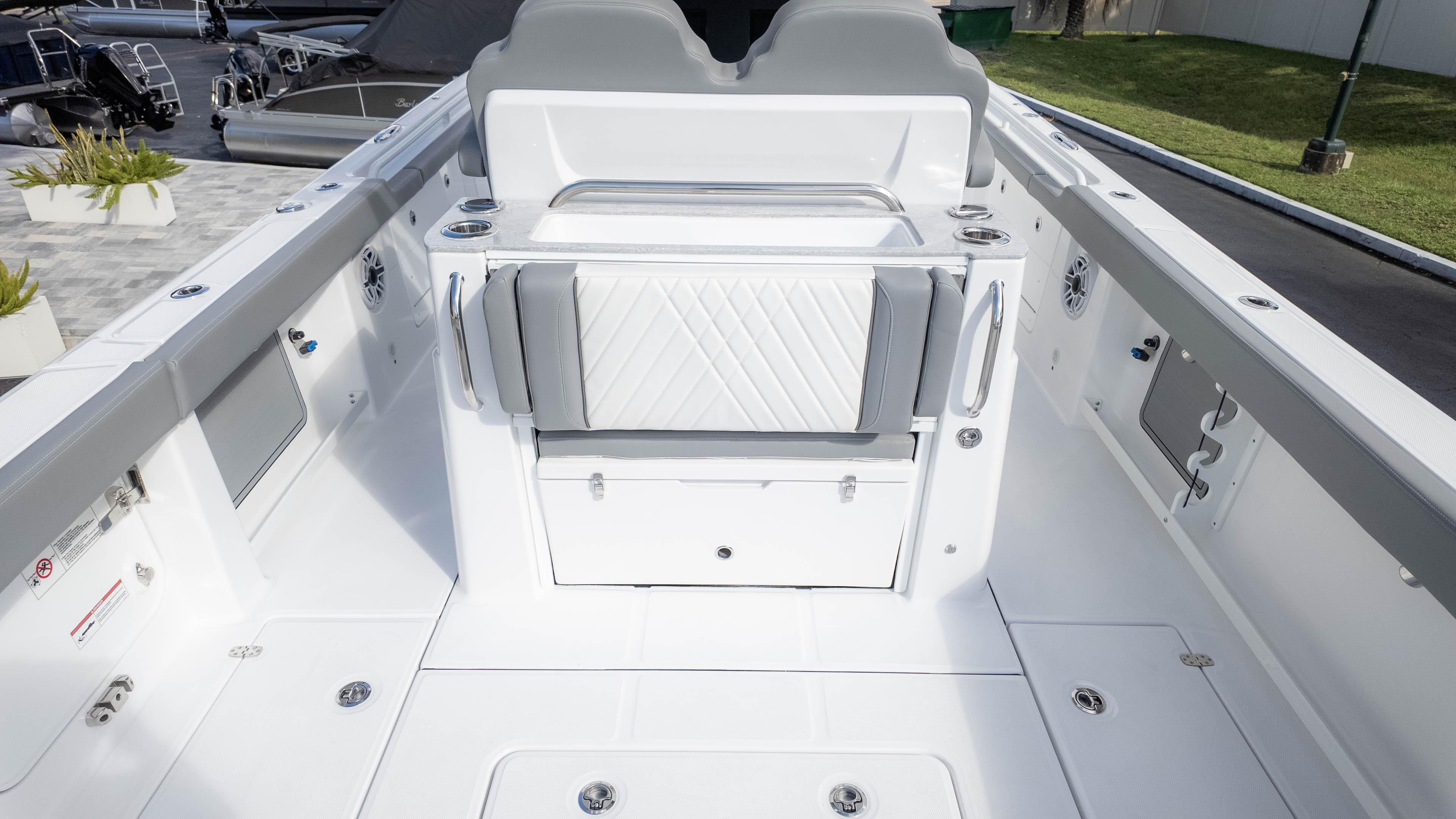 2025 Everglades 315 Center Console boat interior with sleek white seating and storage.
