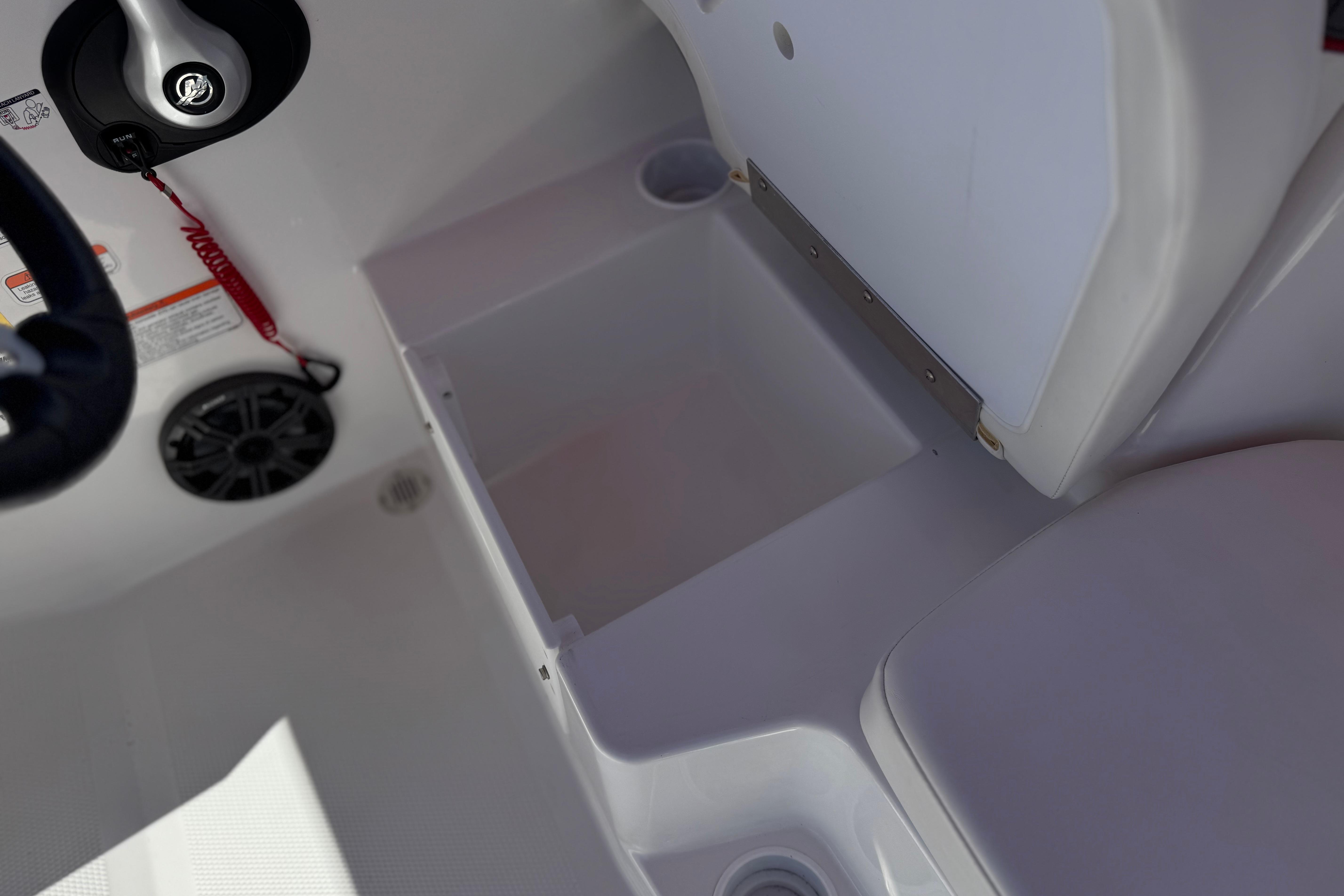 2024 Tahoe T16 boat interior with storage compartment and steering wheel.