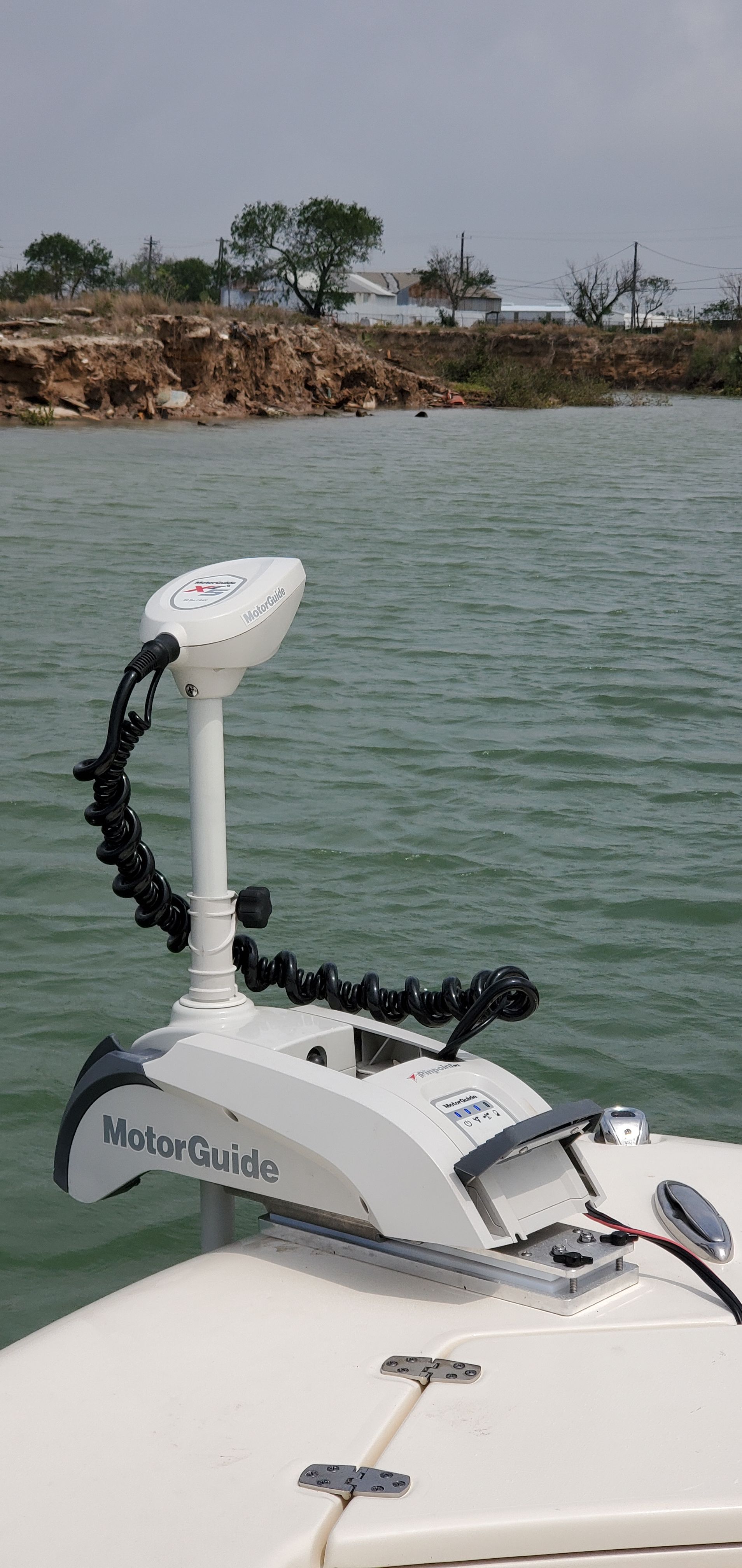 A 2021 Scout 195 Sportfish with a MotorGuide motor on calm water.