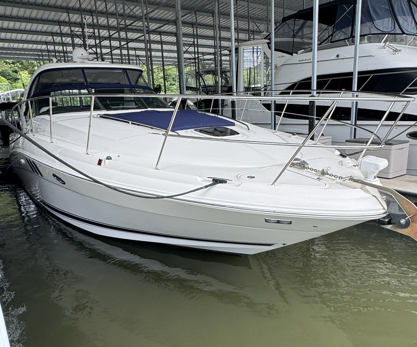 A 2007 Sea Ray 40 Sundancer docked in a covered marina.