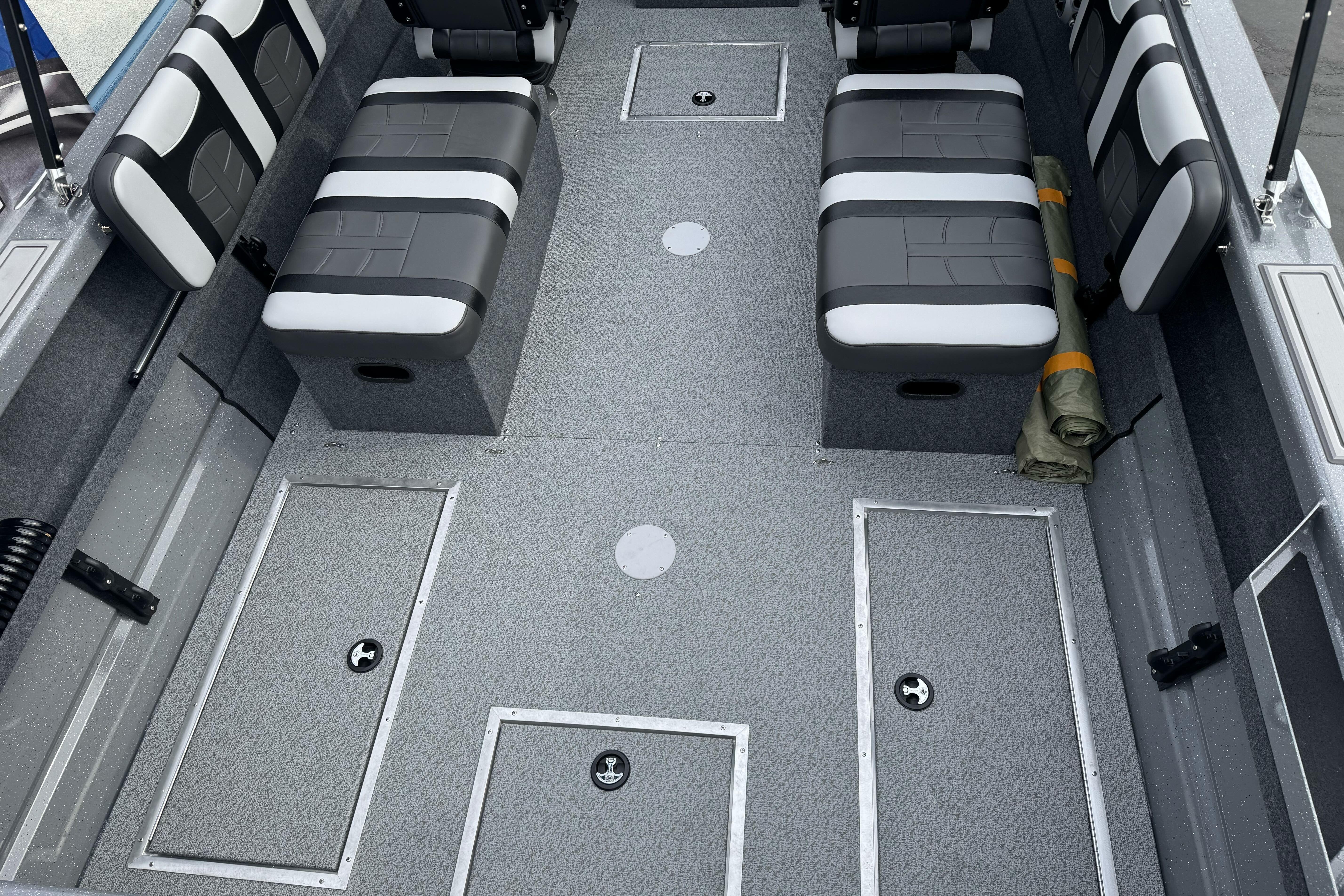 2026 Lund 185 Heavy Gauge boat interior with gray seating and storage compartments.