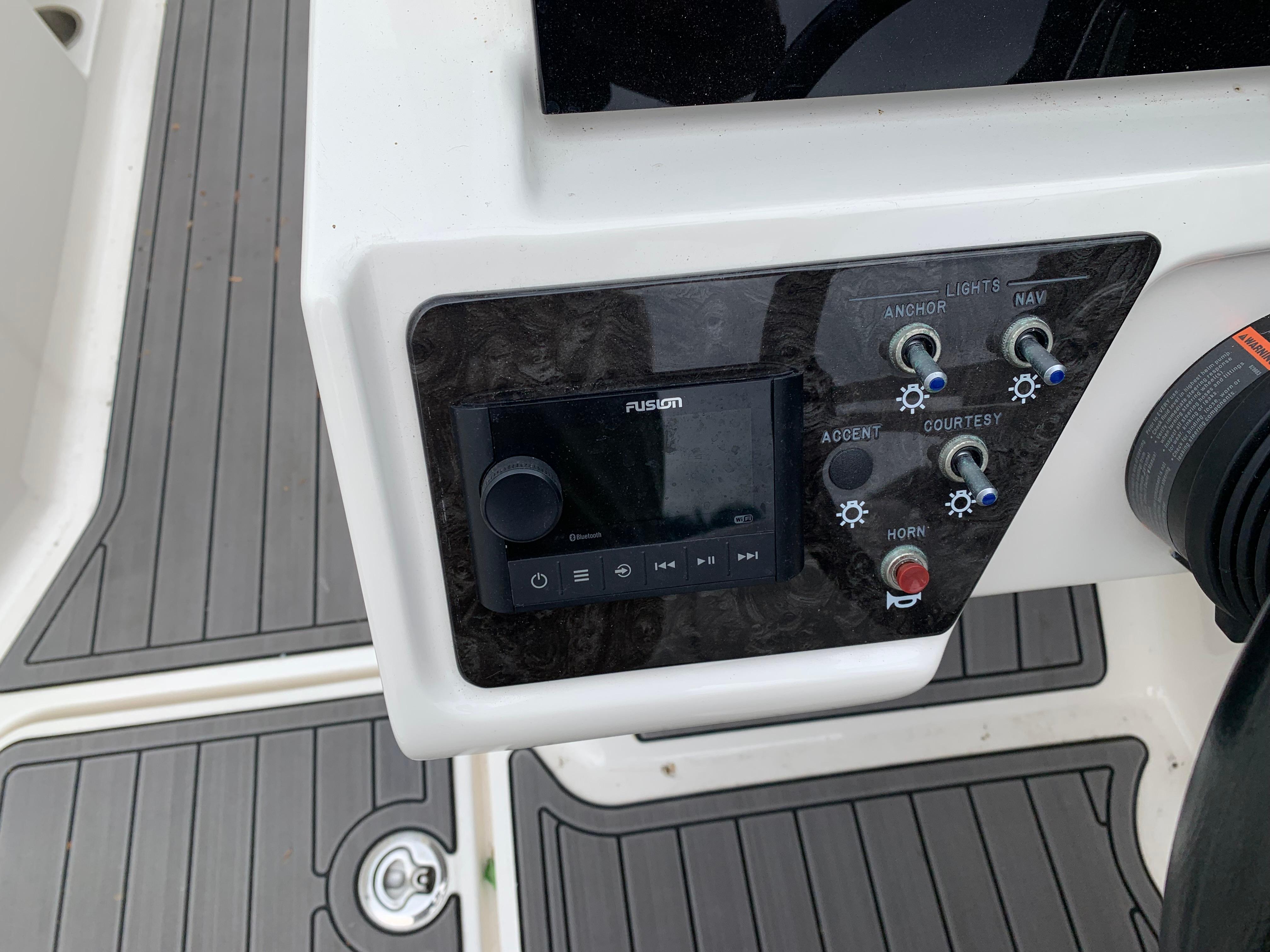 Control panel of a 2020 Sea Ray SPX 190 Outboard boat with audio system and switches.