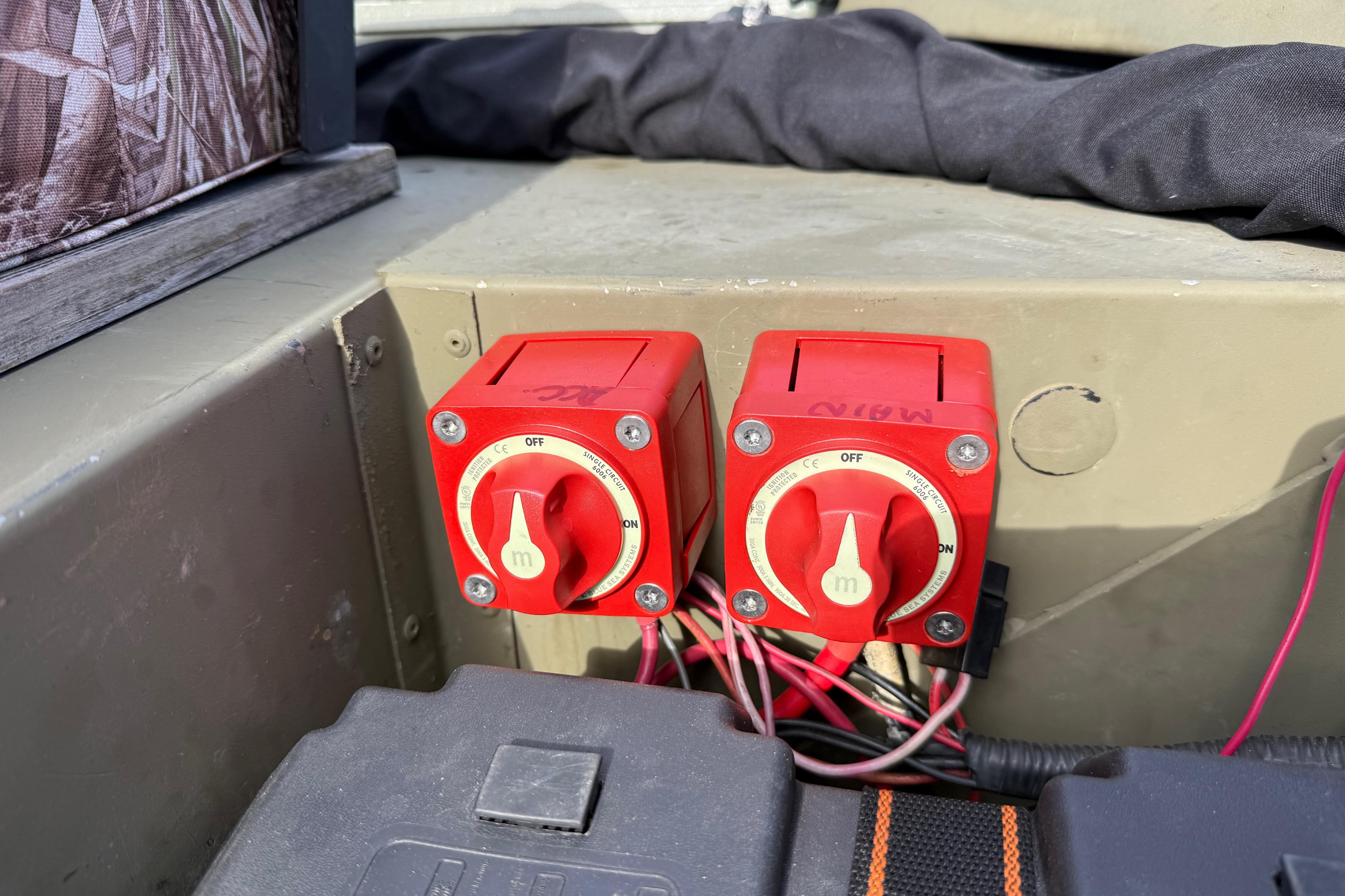 Red battery switches on a 2020 Lowe Roughneck 2070 Big River boat.