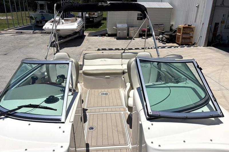 2007 Sea Ray 240 Sundeck boat with open deck and seating area.