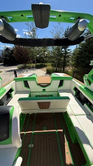 Interior of a 2018 Nautique Super Air Nautique G23 with green and white seating.
