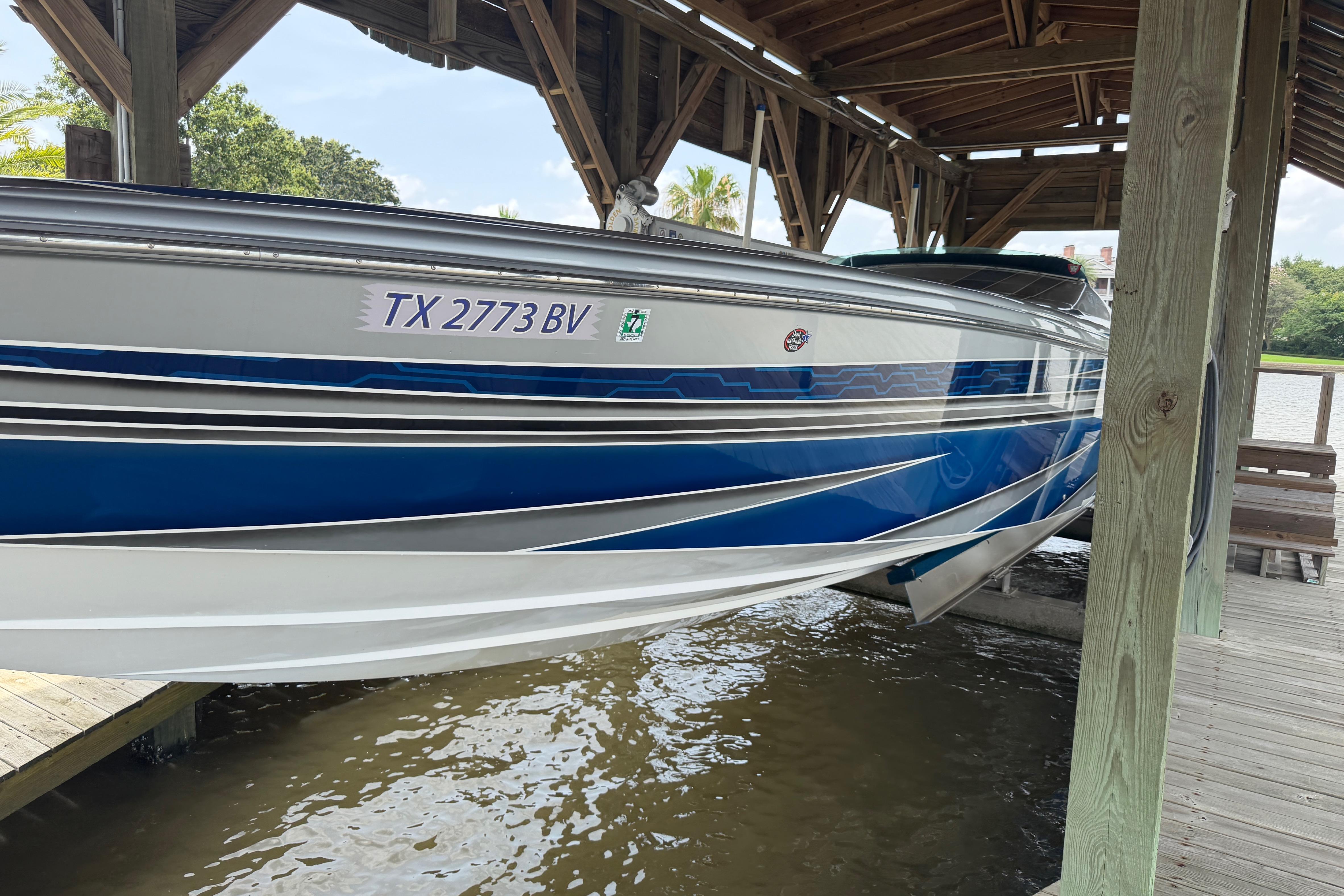 2013 Nor-Tech 477 SPX Vee Bottom boat docked, featuring sleek blue and white design.