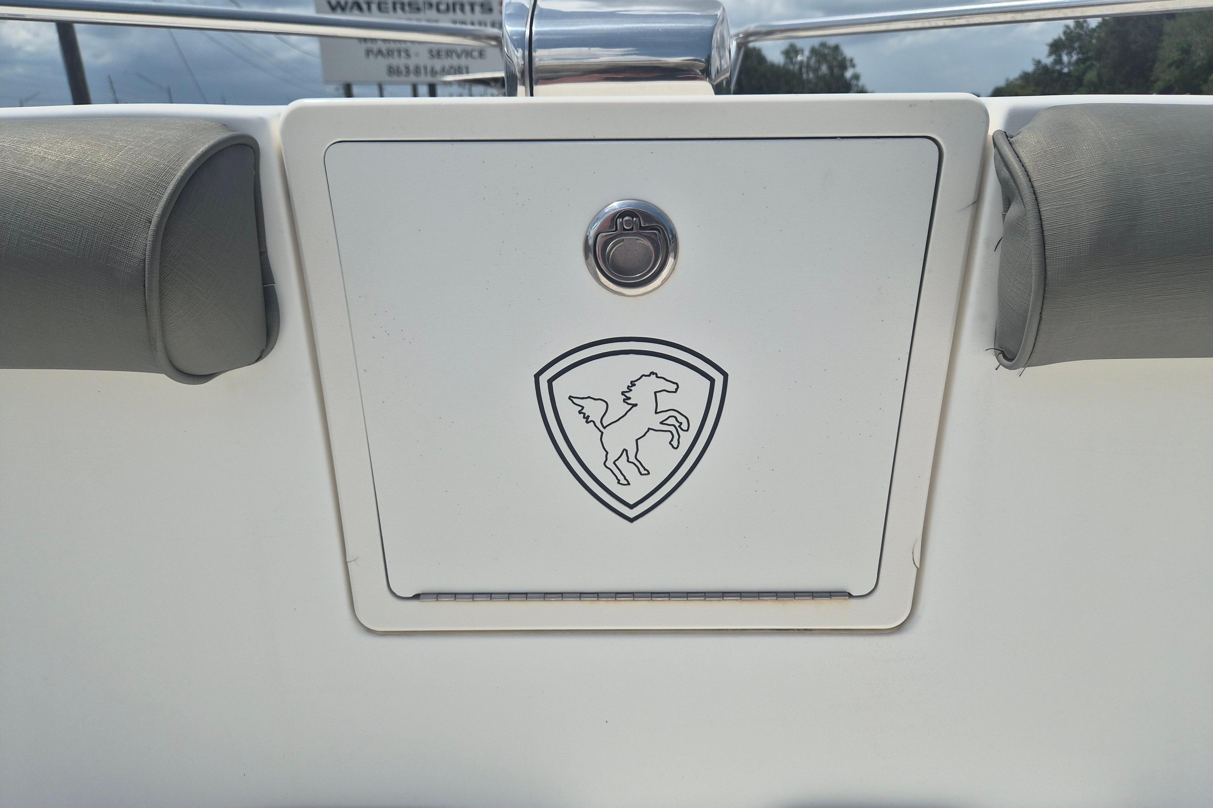 2006 Century 2900 Center Console boat with horse emblem on storage compartment.