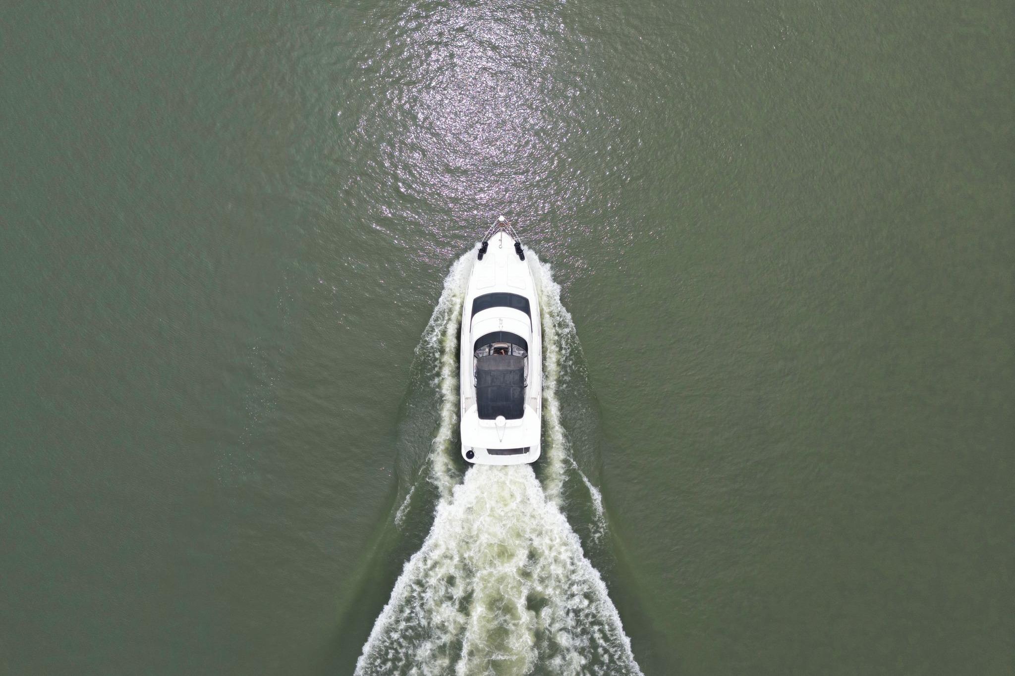 Aerial view of 2005 Carver 39 Motor Yacht cruising on open water.