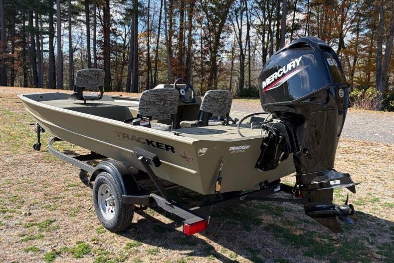 2026 Tracker Grizzly 1754 SC boat with Mercury engine on trailer, parked outdoors.