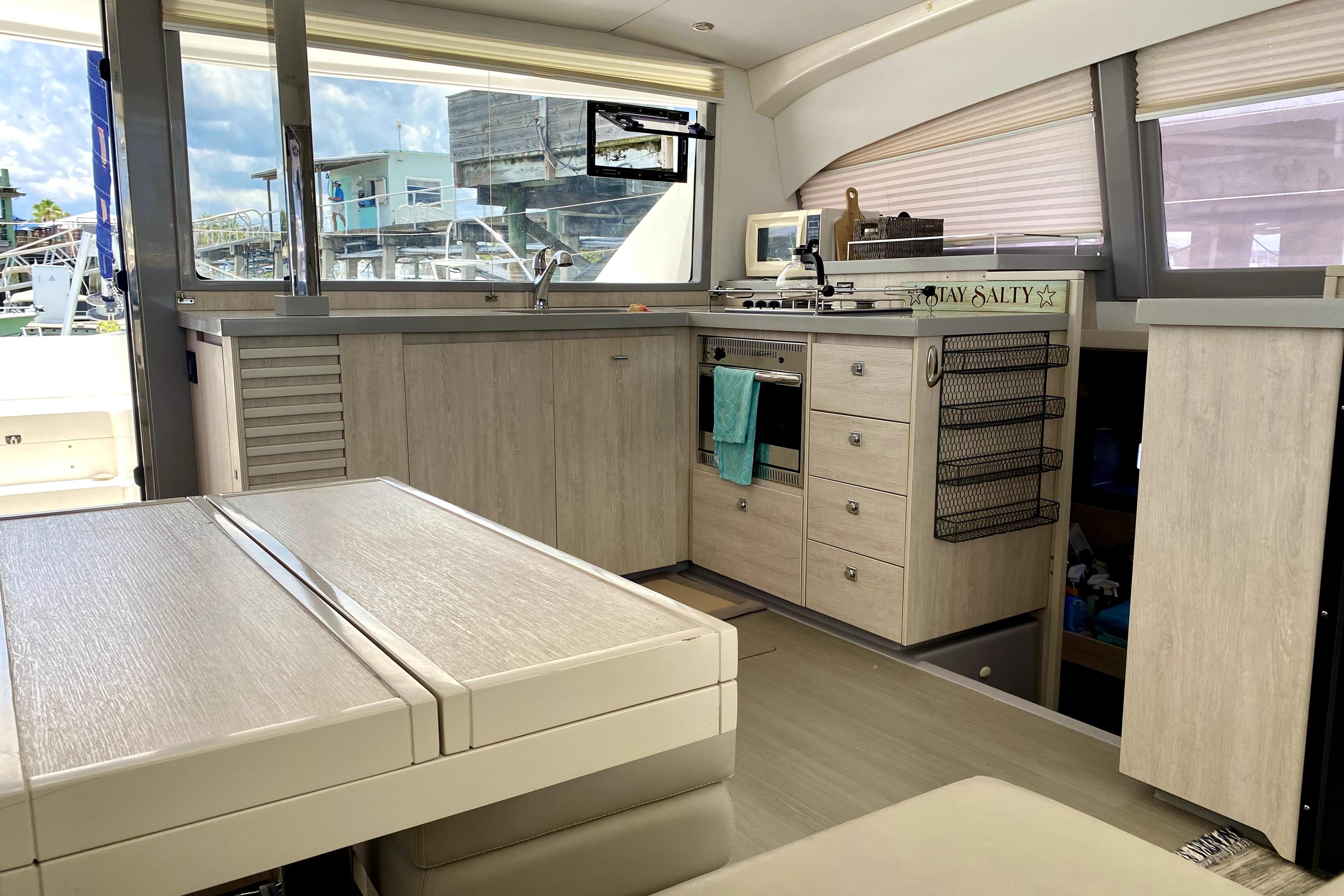 Interior of a 2017 Leopard 40 yacht featuring a modern kitchen and dining area.
