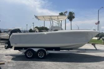 2023 Sailfish 242 CC boat on trailer, parked outdoors under a clear sky.