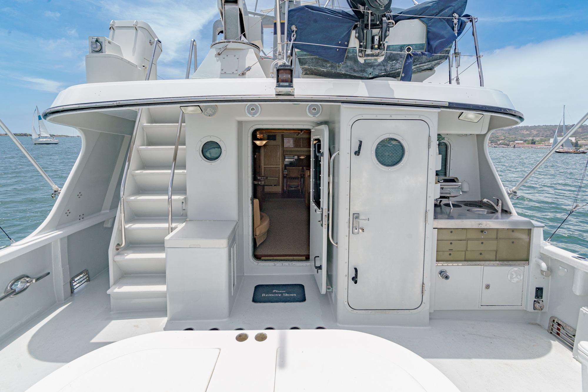 1990 Seaton Long Range Cruiser yacht deck with stairs and open cabin door.
