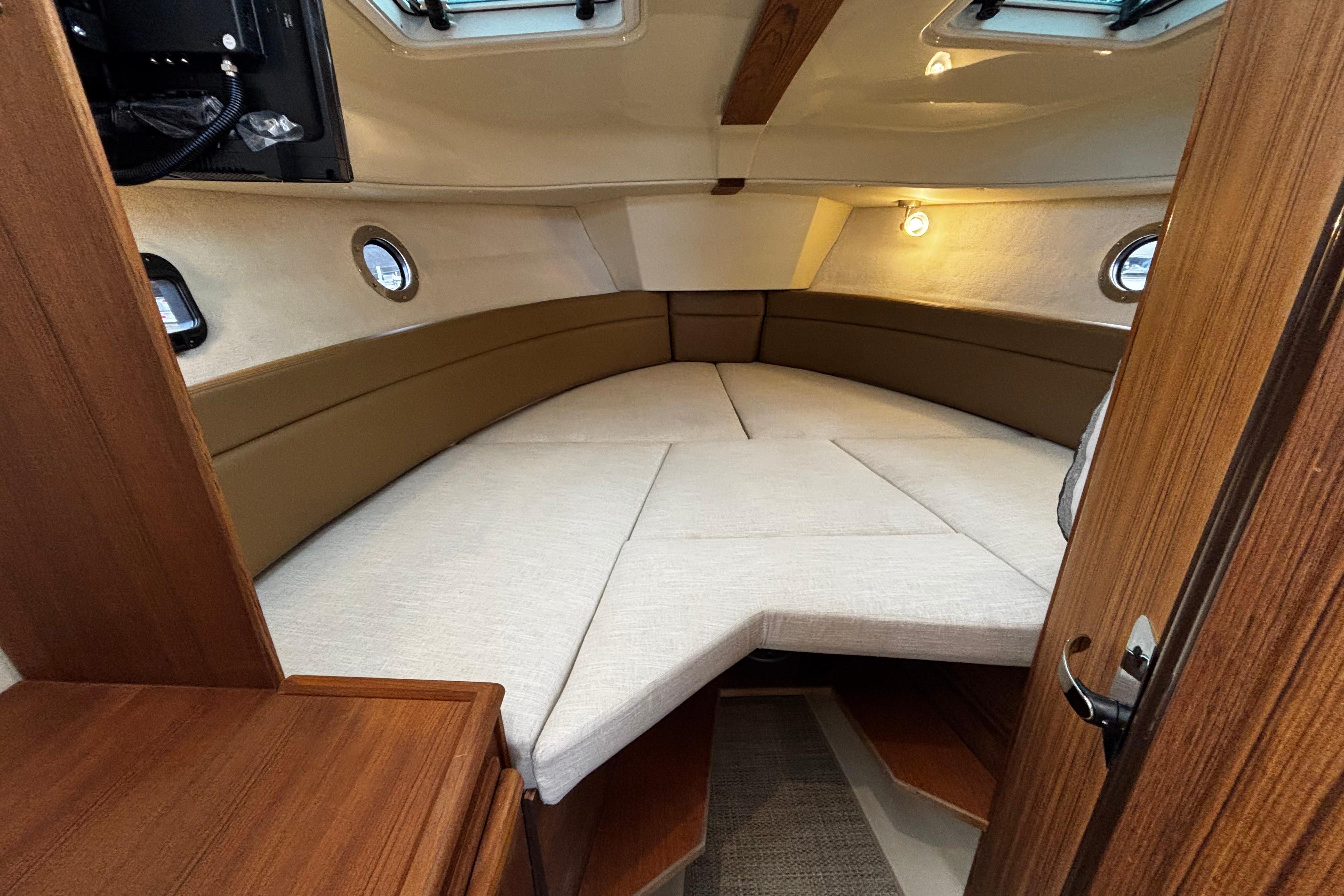 Interior of 2026 Ranger Tugs R-25 yacht with cozy sleeping area.