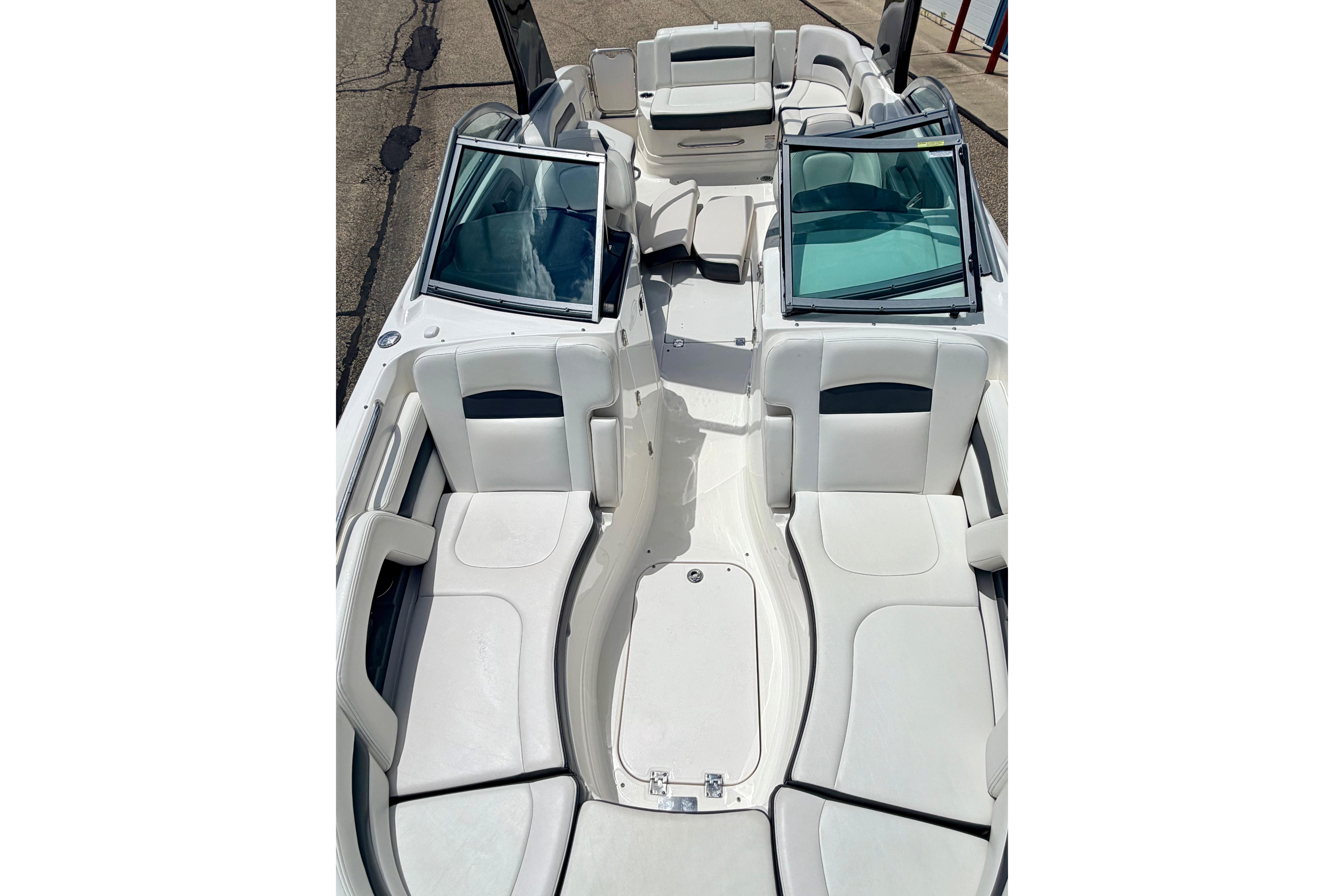 2015 Chaparral Sunesta 264 boat interior with white seating and open windshield.