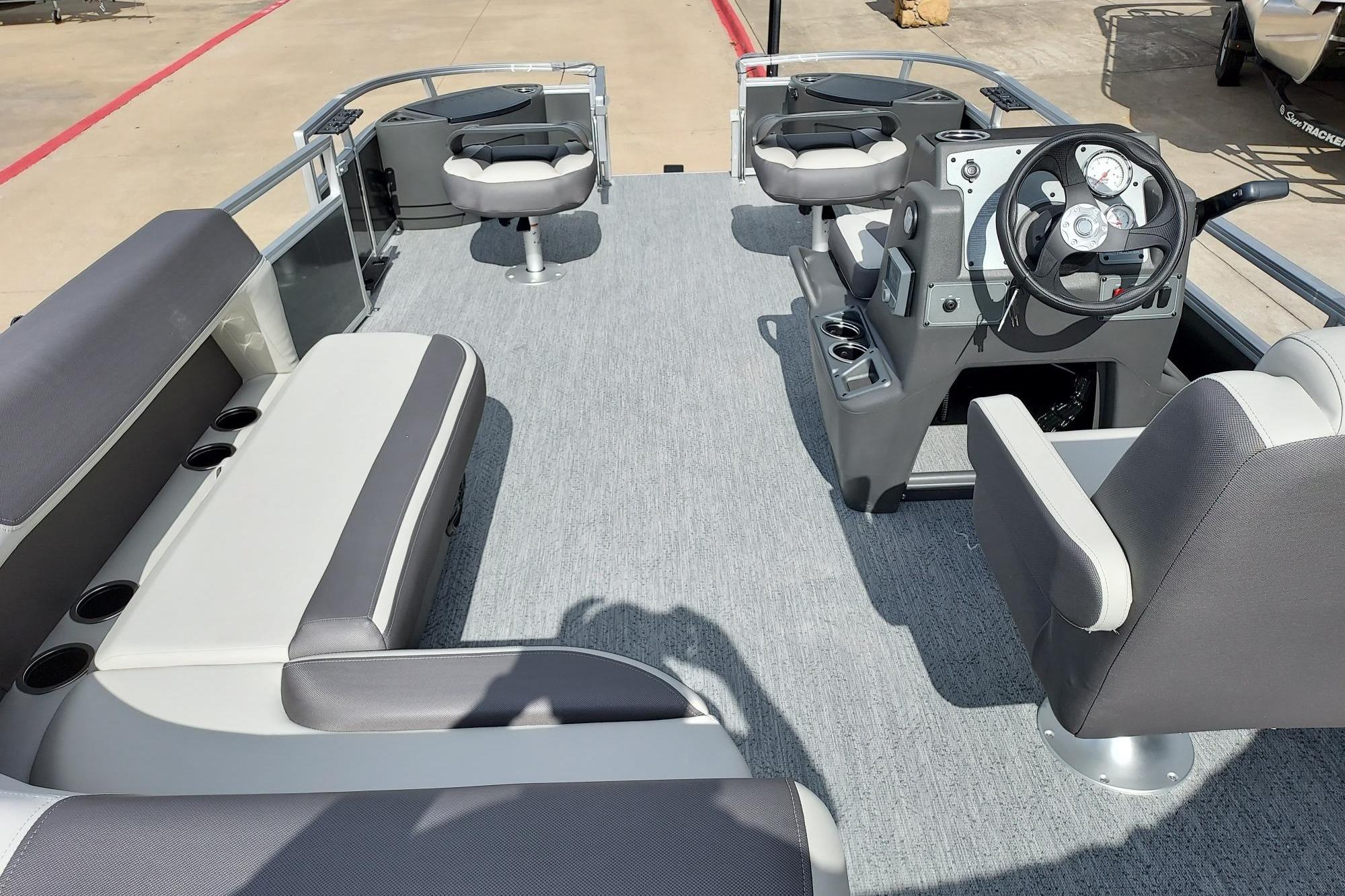 2026 Sun Tracker Bass Buggy 18 DLX pontoon boat interior with seating and steering console.