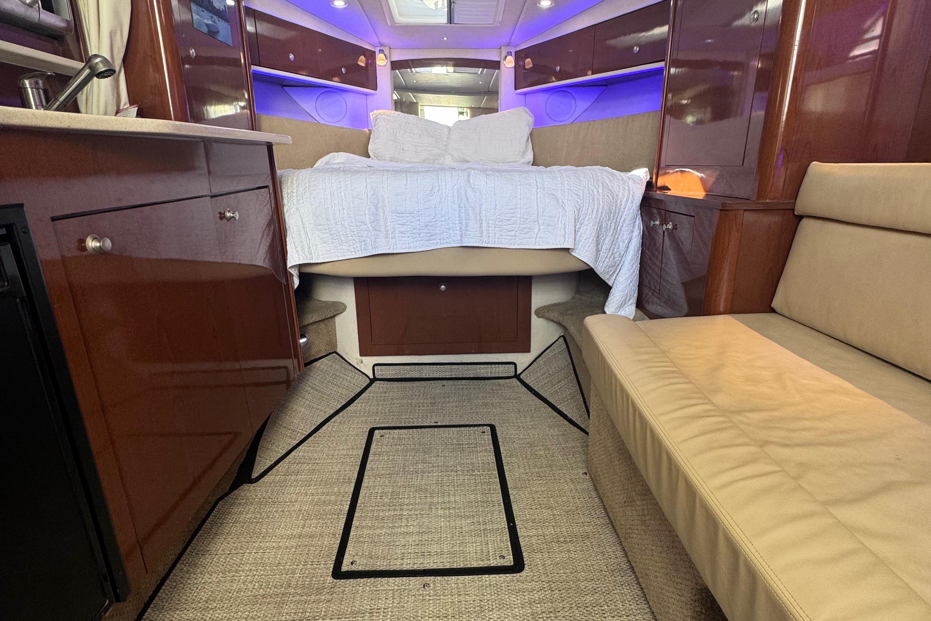 Interior of 2008 Sea Ray 350 Sundancer yacht with cozy bed and seating area.