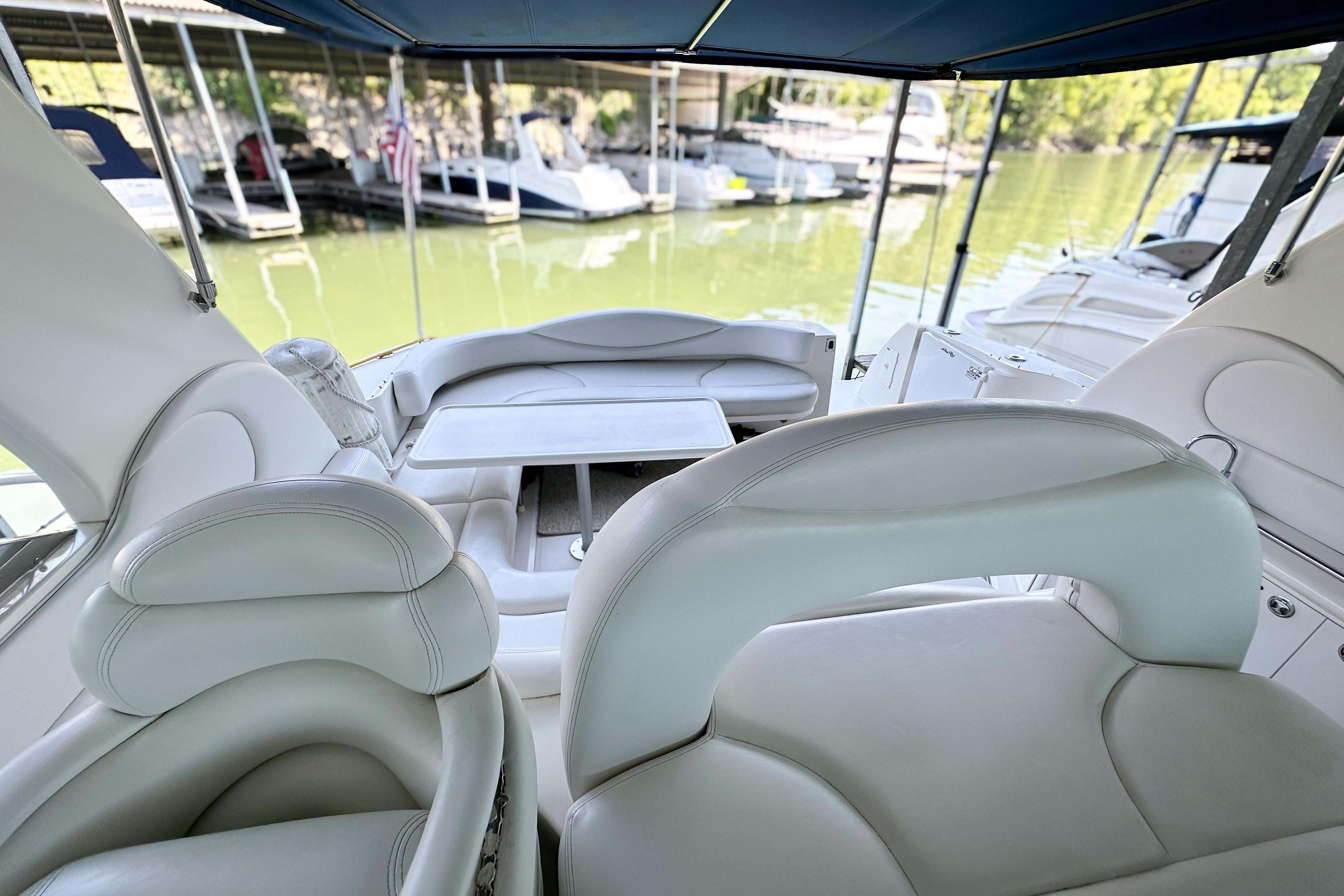 Interior view of 2001 Sea Ray 410 Sundancer yacht with white seating and table.