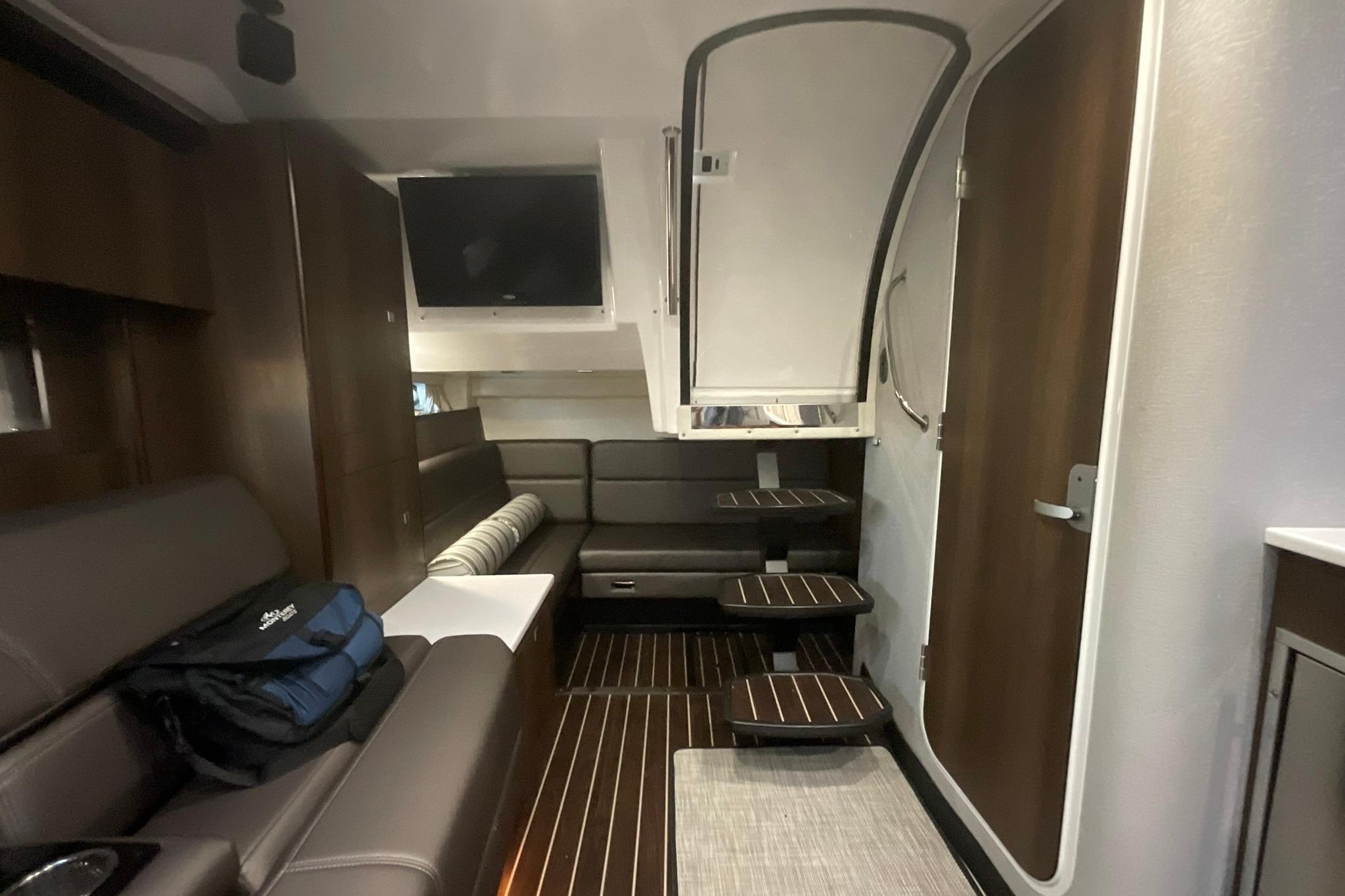 Interior of 2019 Monterey 335 Sport Yacht with modern seating and wooden accents.