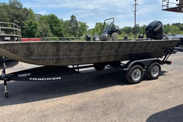 2026 Tracker Grizzly 2072 CC boat on trailer, parked outdoors.