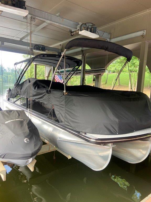 2023 Harris FloteBote 250 Grand Mariner pontoon boat covered in dock.