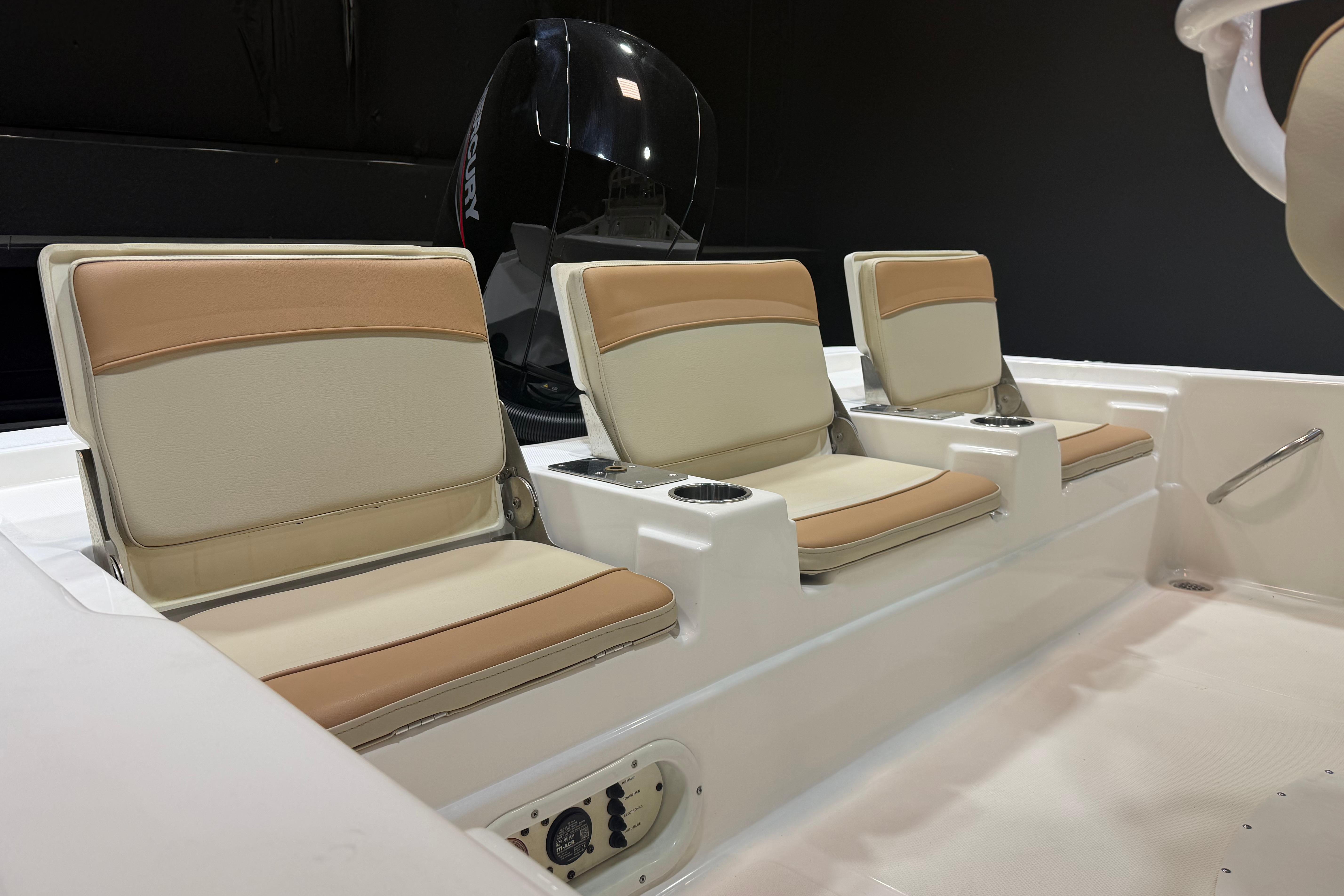 2023 NauticStar 215 XTS boat interior with beige seating and Mercury engine.
