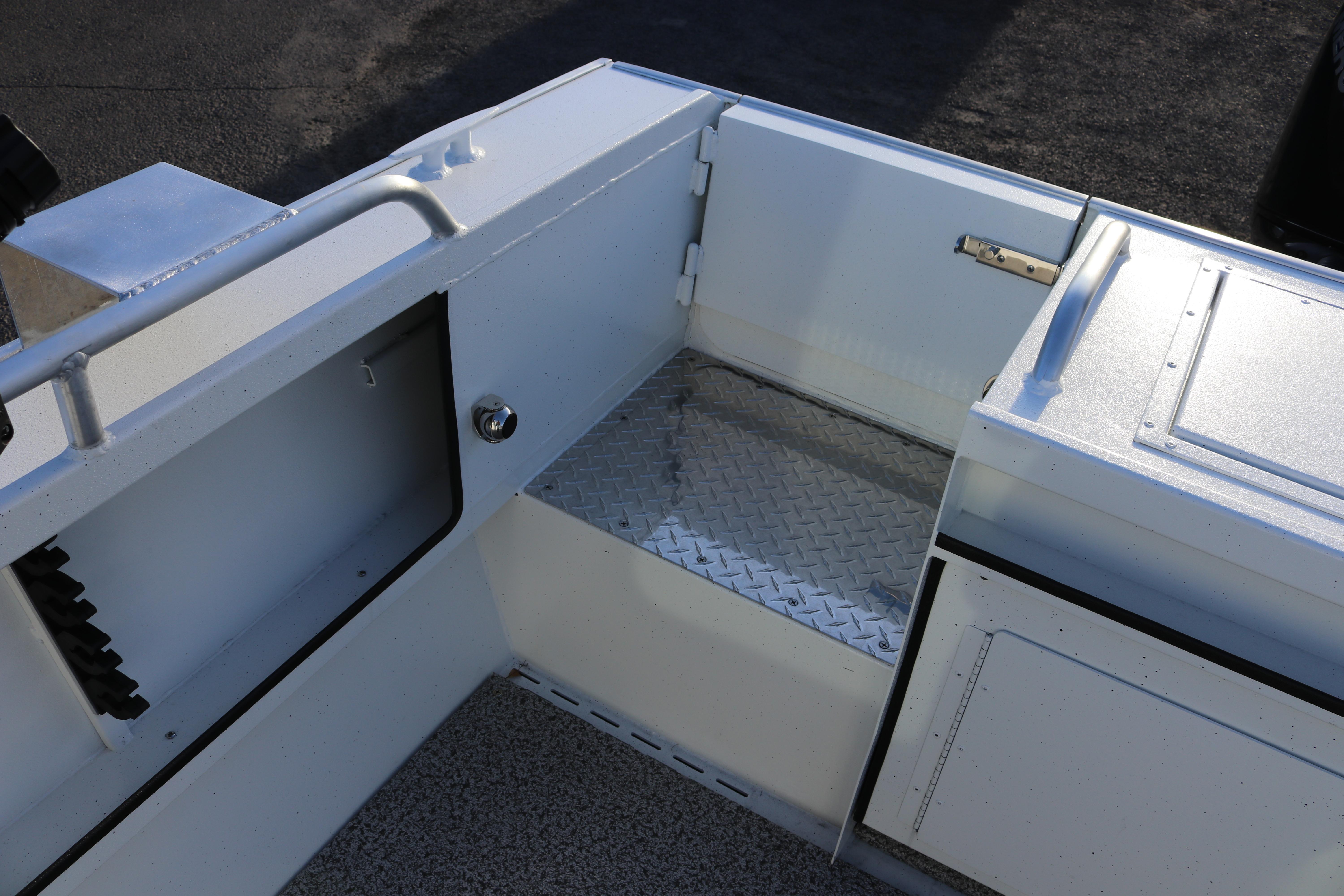 2026 Alumaweld Intruder Outboard 22 boat interior with storage compartments and diamond plate flooring.