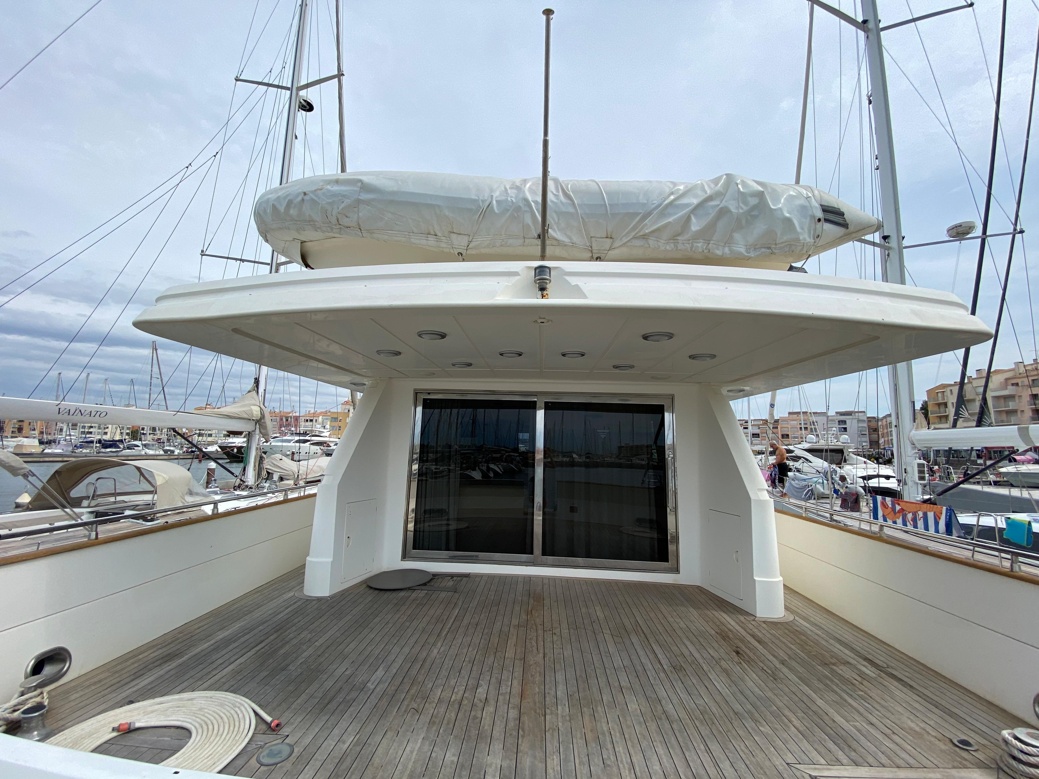1994 Falcon 76 yacht with spacious deck in harbor.