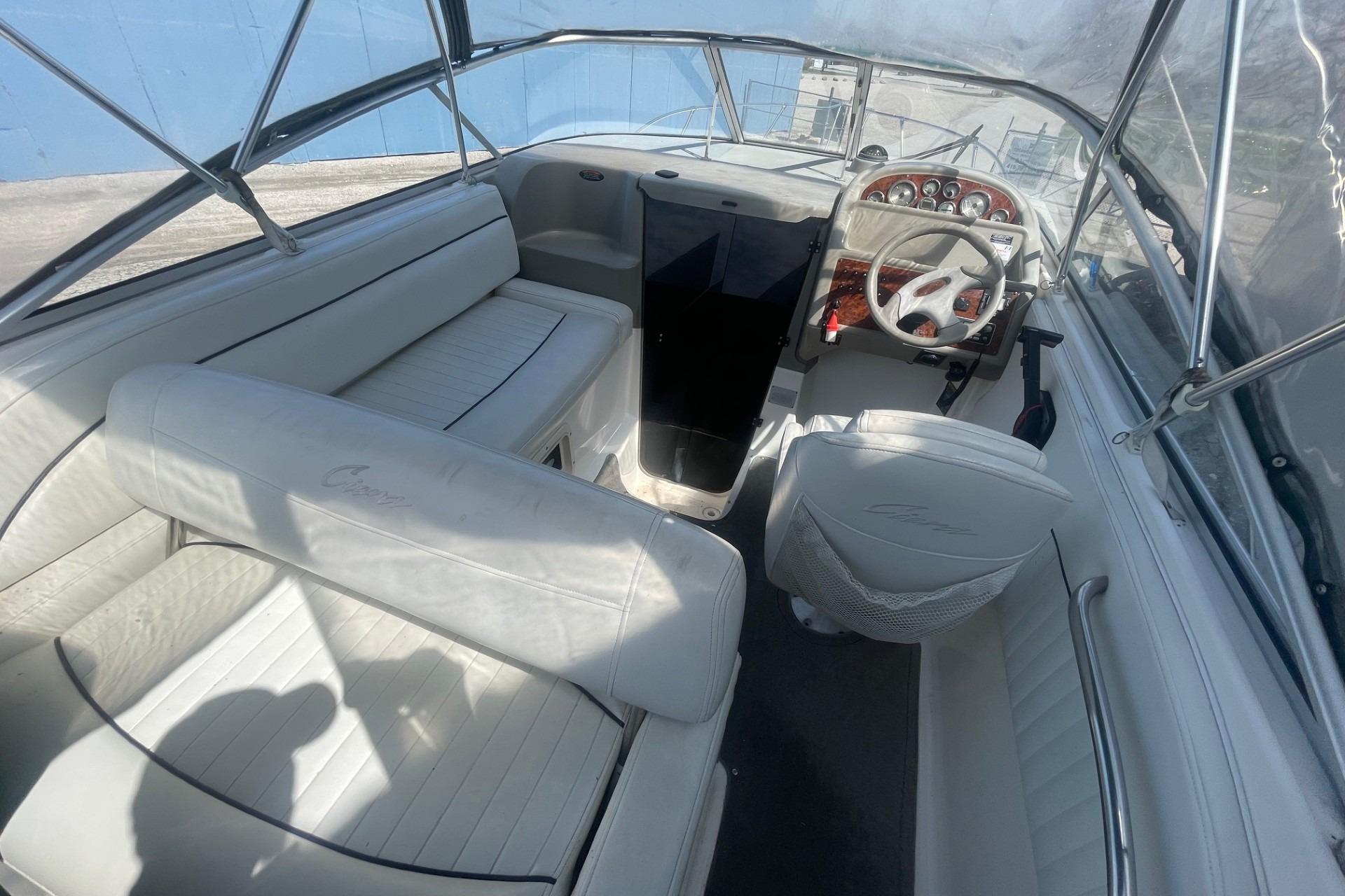 1997 Bayliner 2655 Ciera boat interior with white seating and steering wheel.
