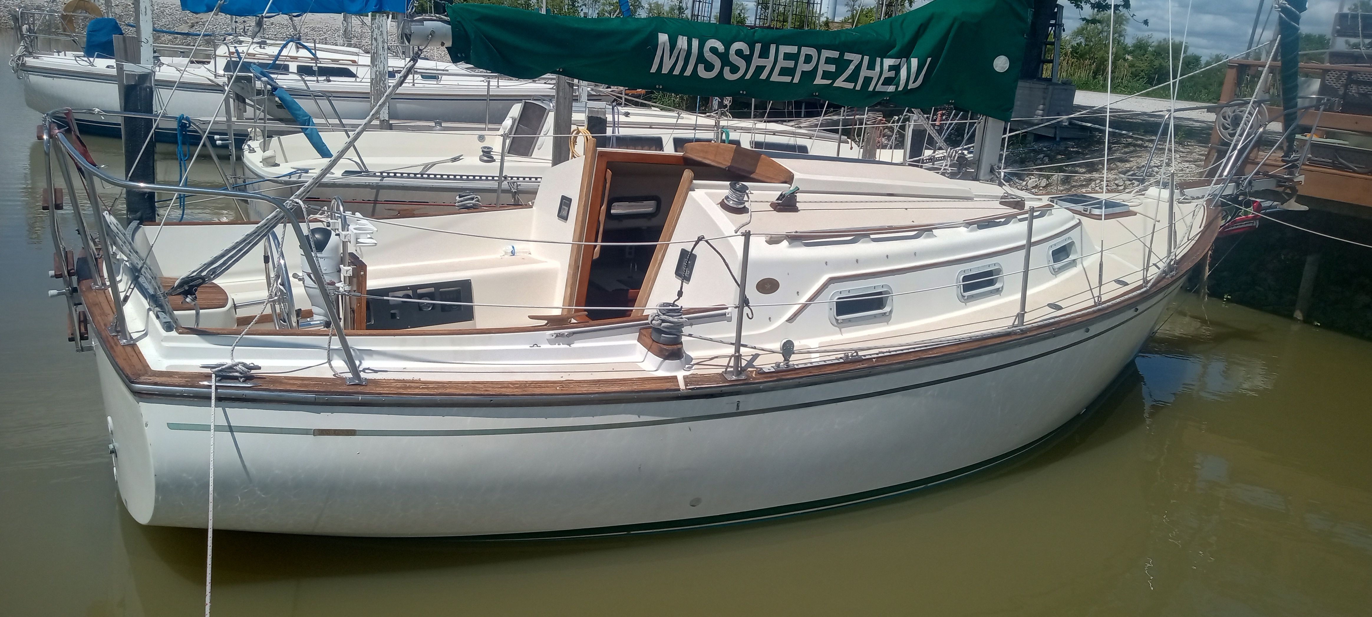 1983 Island Packet MKII sailboat docked in harbor.