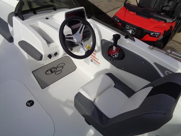 2024 Tahoe T21 boat cockpit with steering wheel and captain's chair.