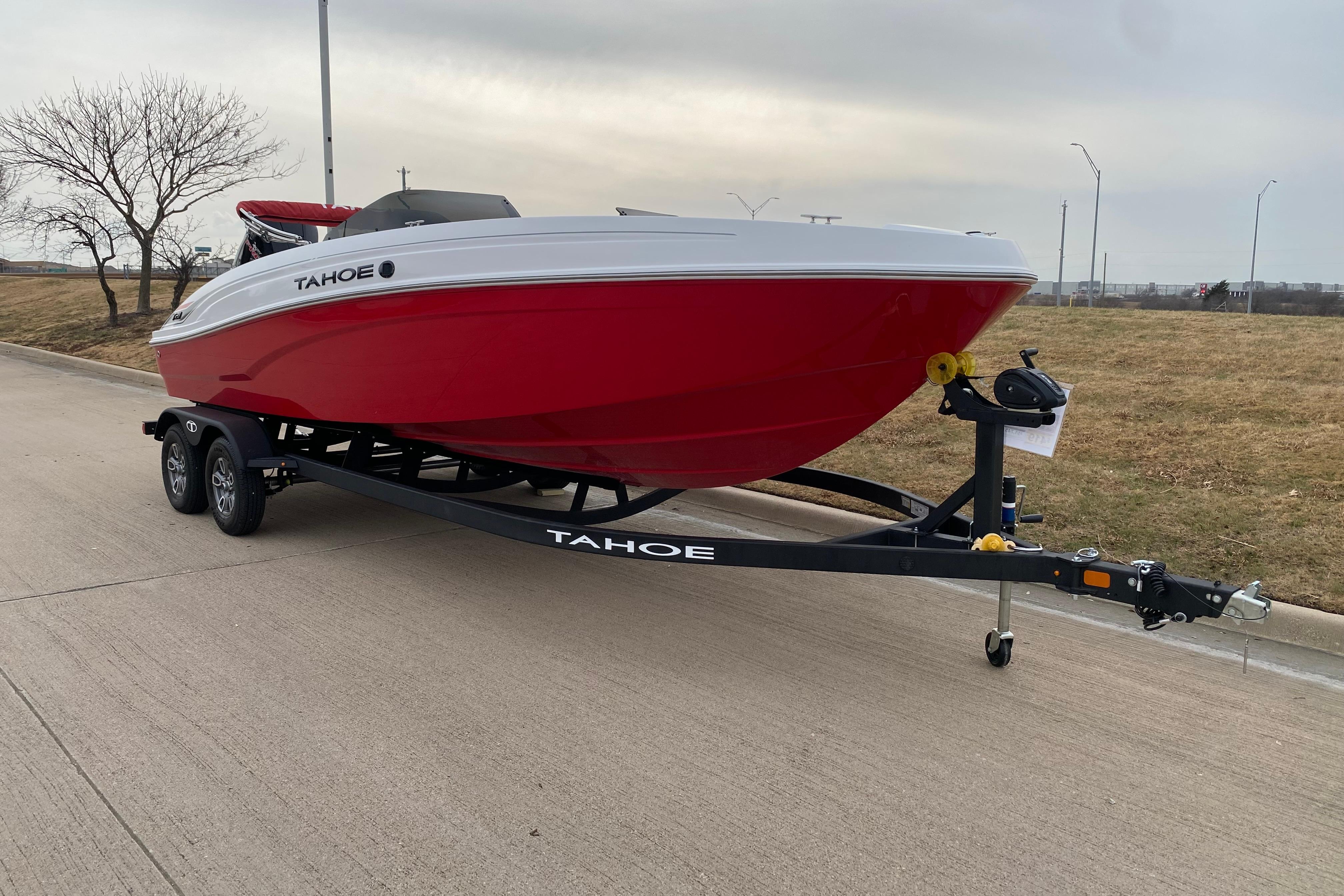 2026 Tahoe T21 boat on trailer, red hull, parked on roadside.