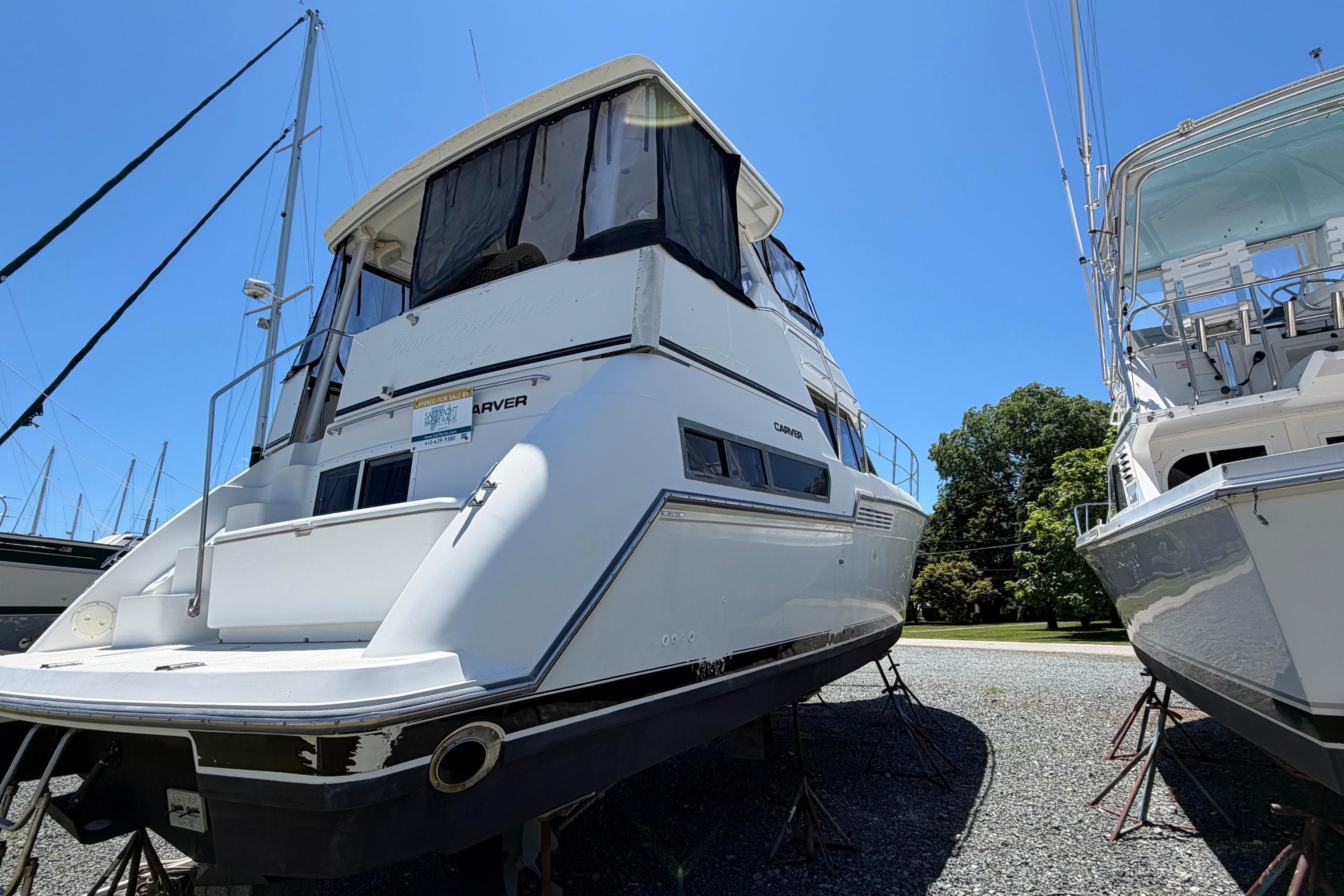 1995 Carver 356 Aft Cabin Motor Yacht on display, surrounded by other boats.