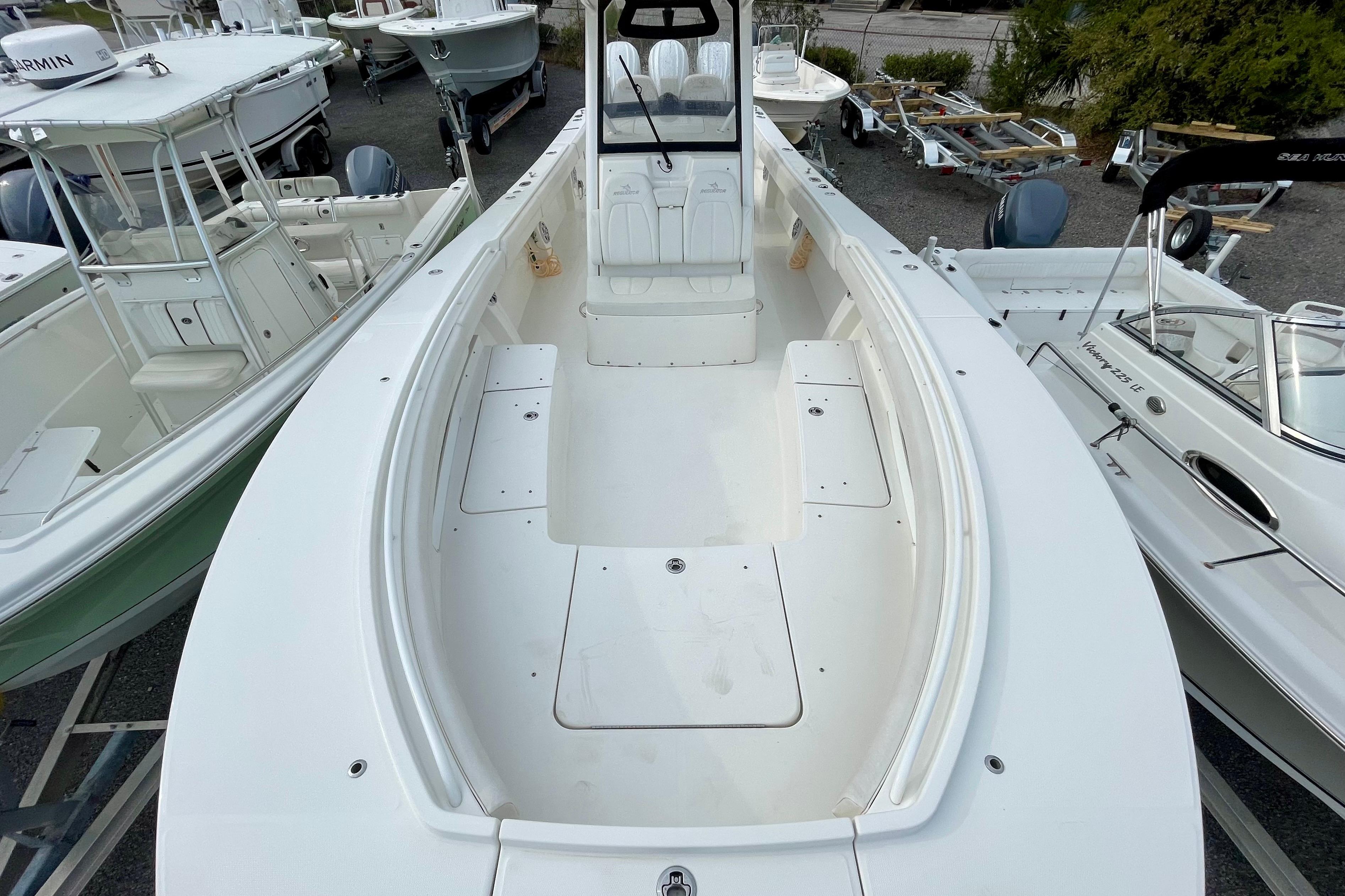 2023 Regulator 34 boat, spacious deck, surrounded by other boats in a marina.