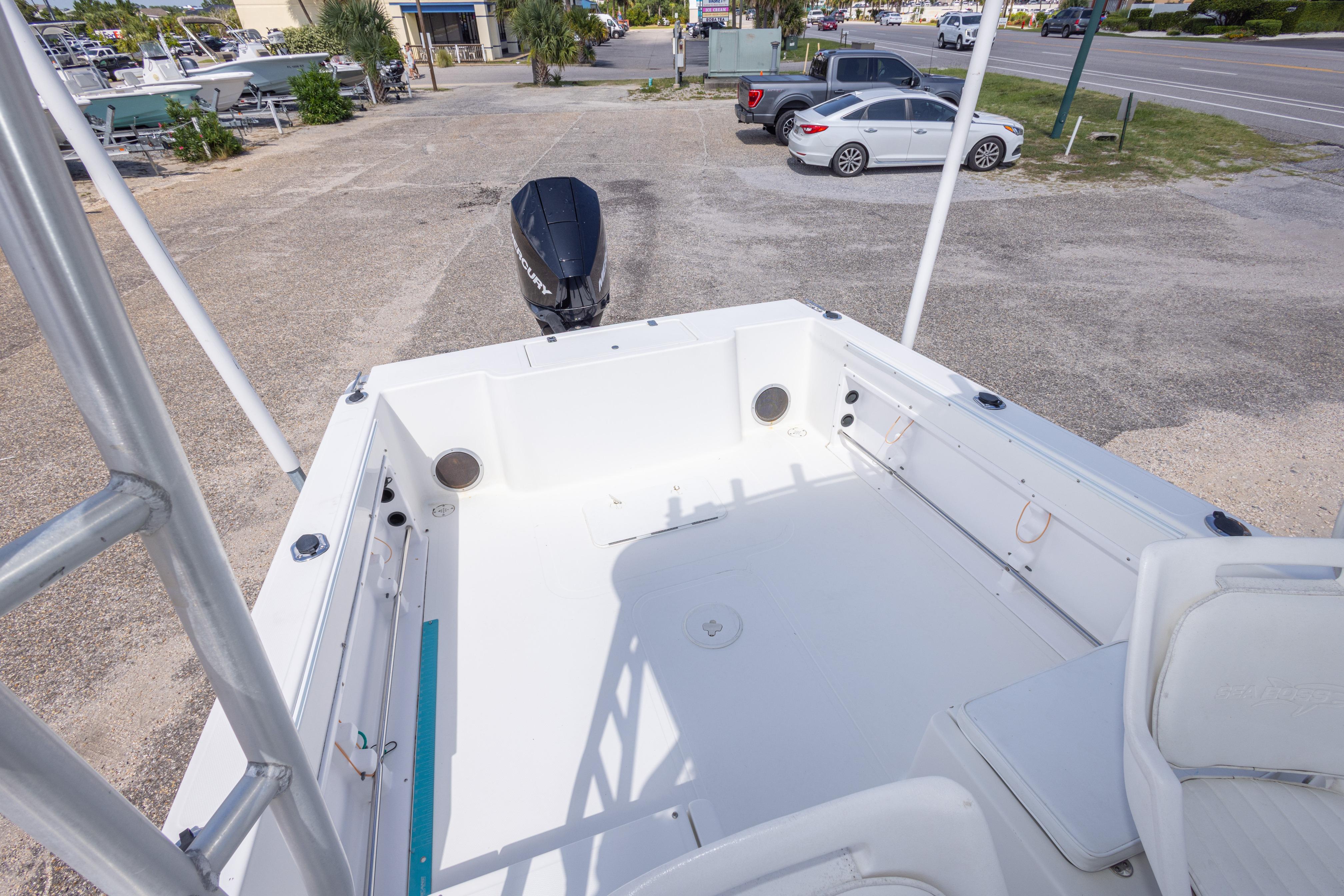 2007 Sea Boss 235 Walkaround boat deck with outboard motor in parking area.