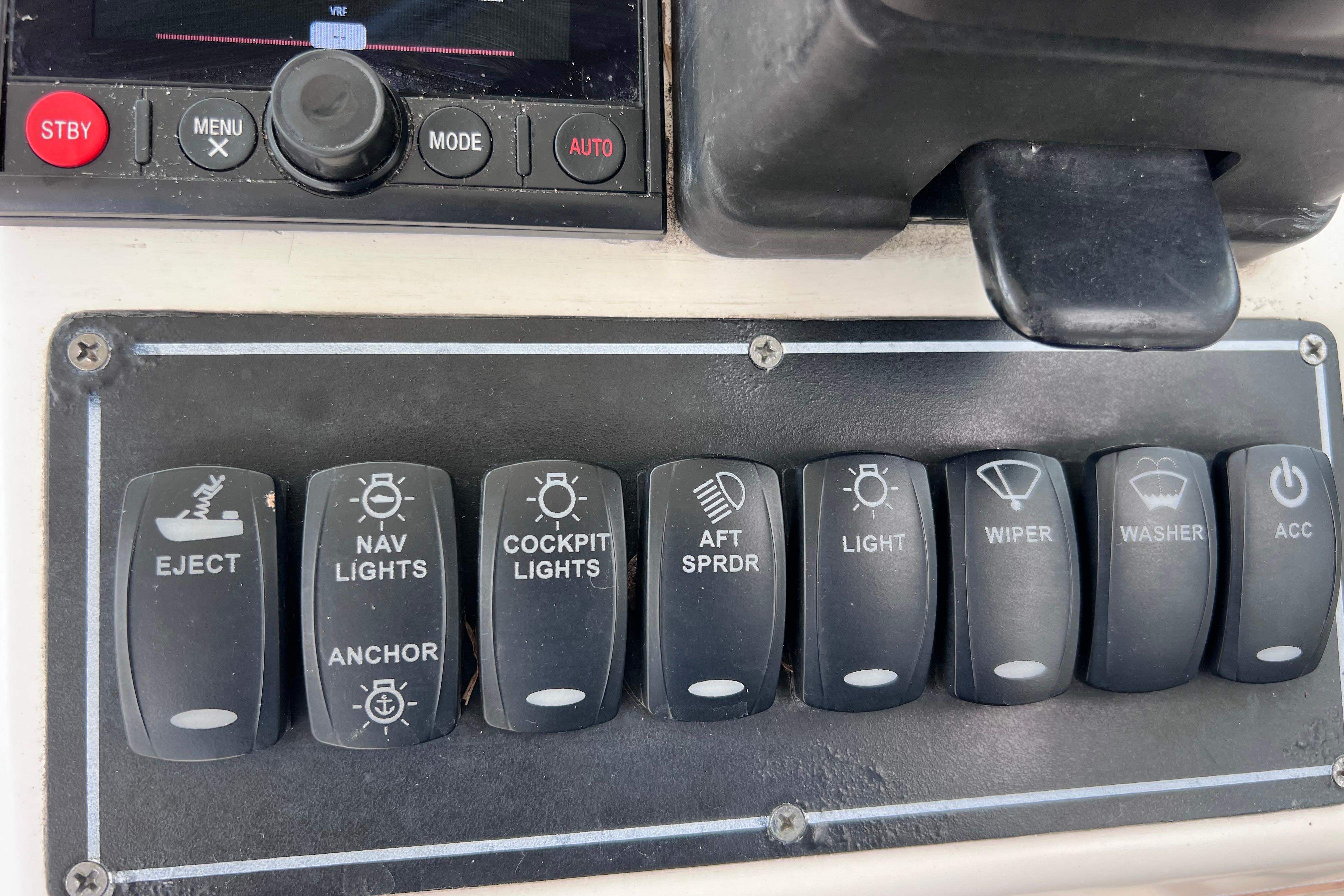 Control panel of a 2005 Pursuit 3070 Offshore boat with labeled switches.