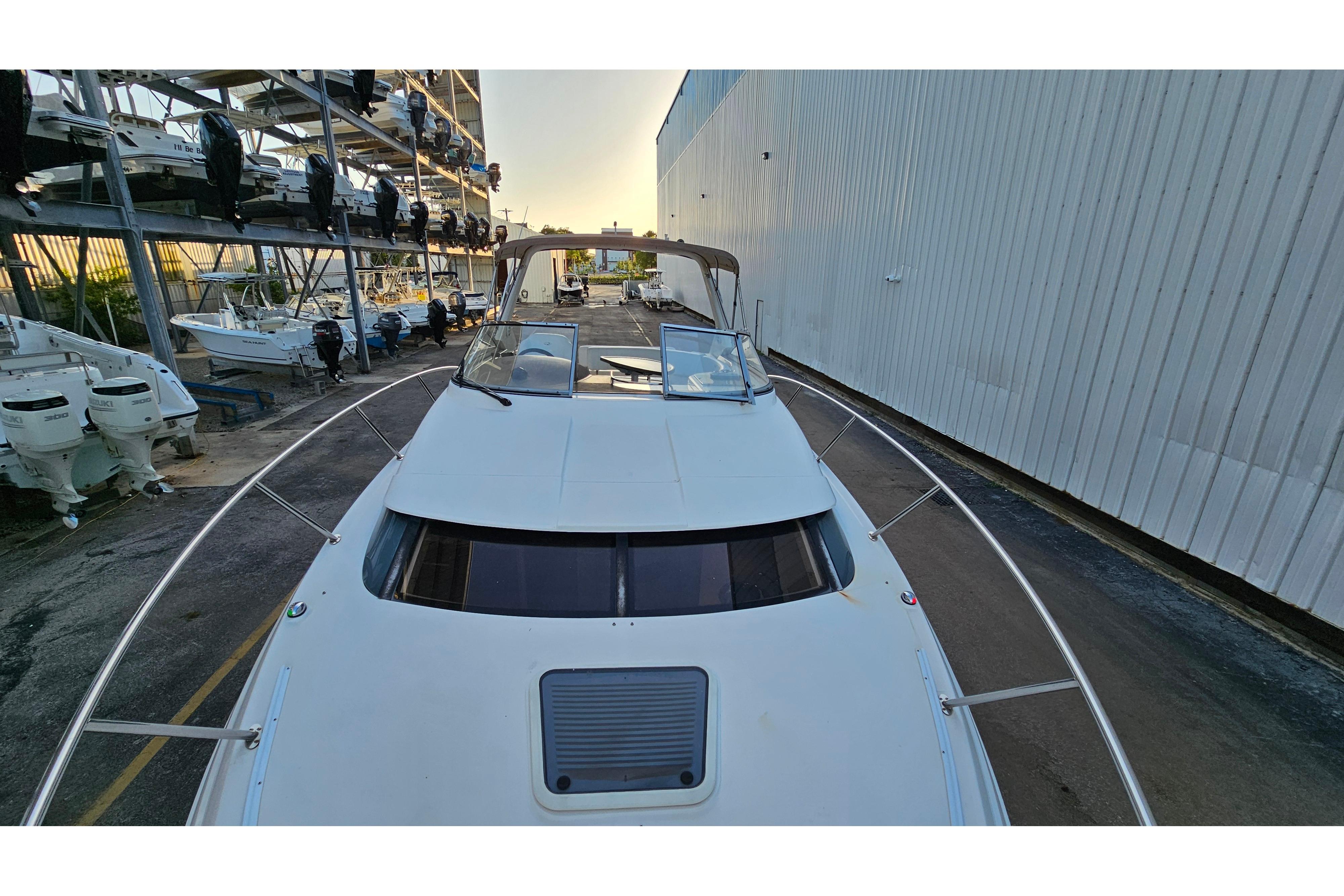 2005 Regal 3060 Window Express boat docked near storage facility.