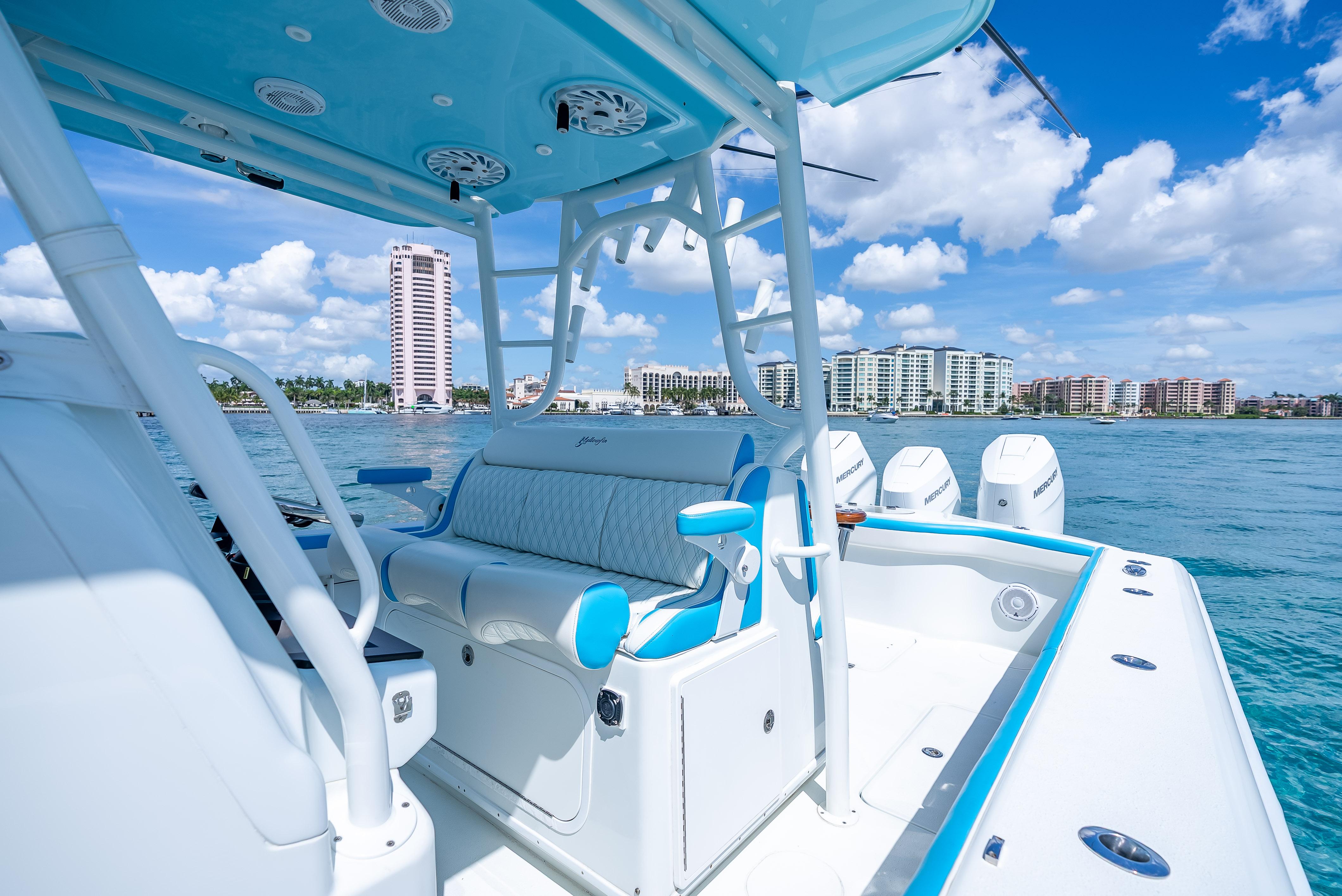 2016 Yellowfin 39 Offshore boat interior with blue accents, ocean view, and city skyline.