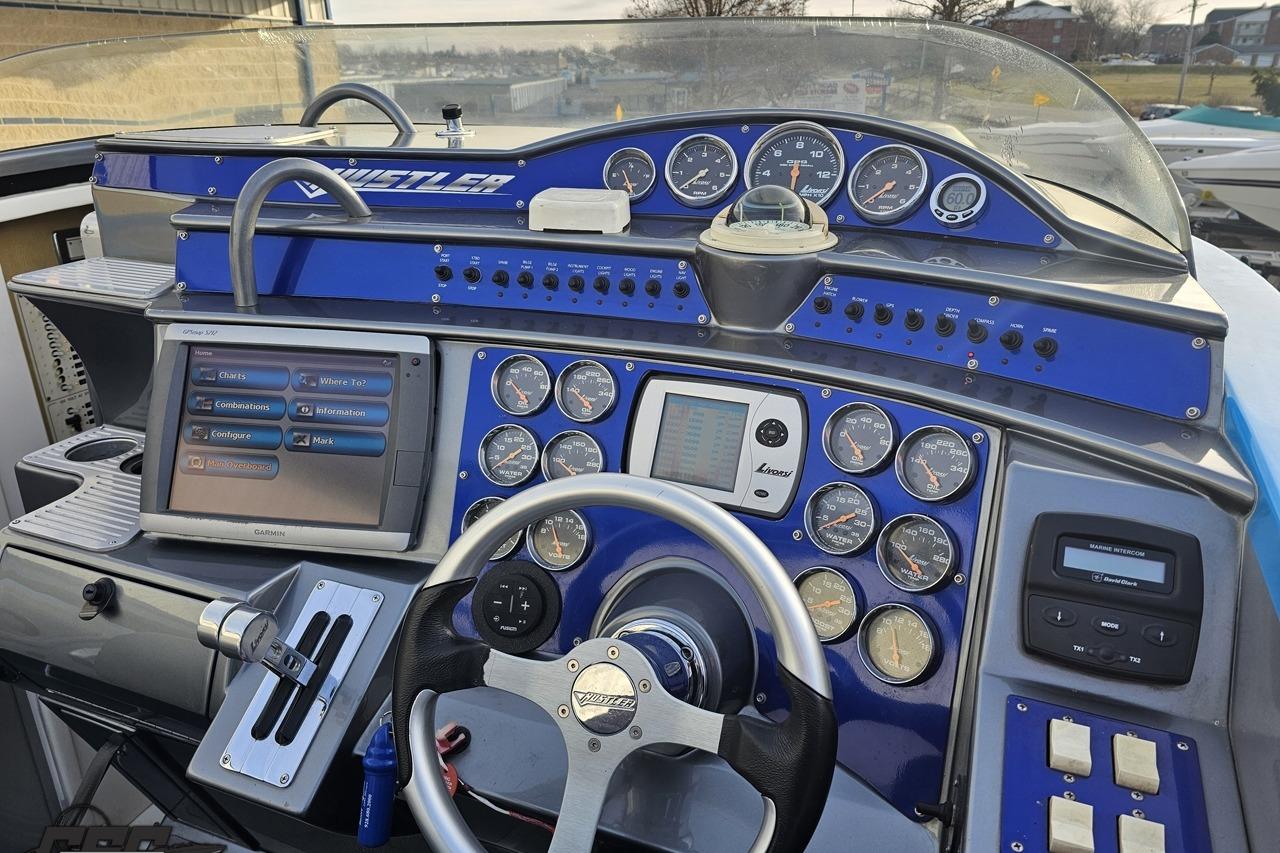 Dashboard of a 2007 Hustler 41 Razor boat with gauges and navigation system.
