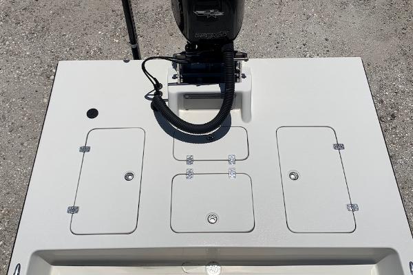2013 SCB R24 boat deck with storage compartments and outboard motor.