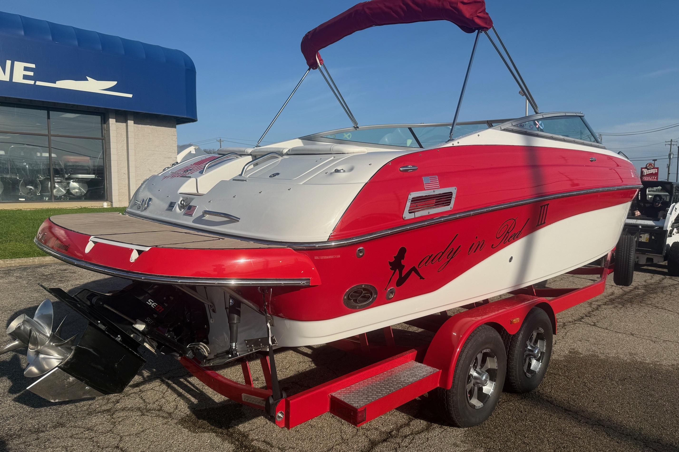 2005 Crownline 270 BR boat with red and white design on a trailer.