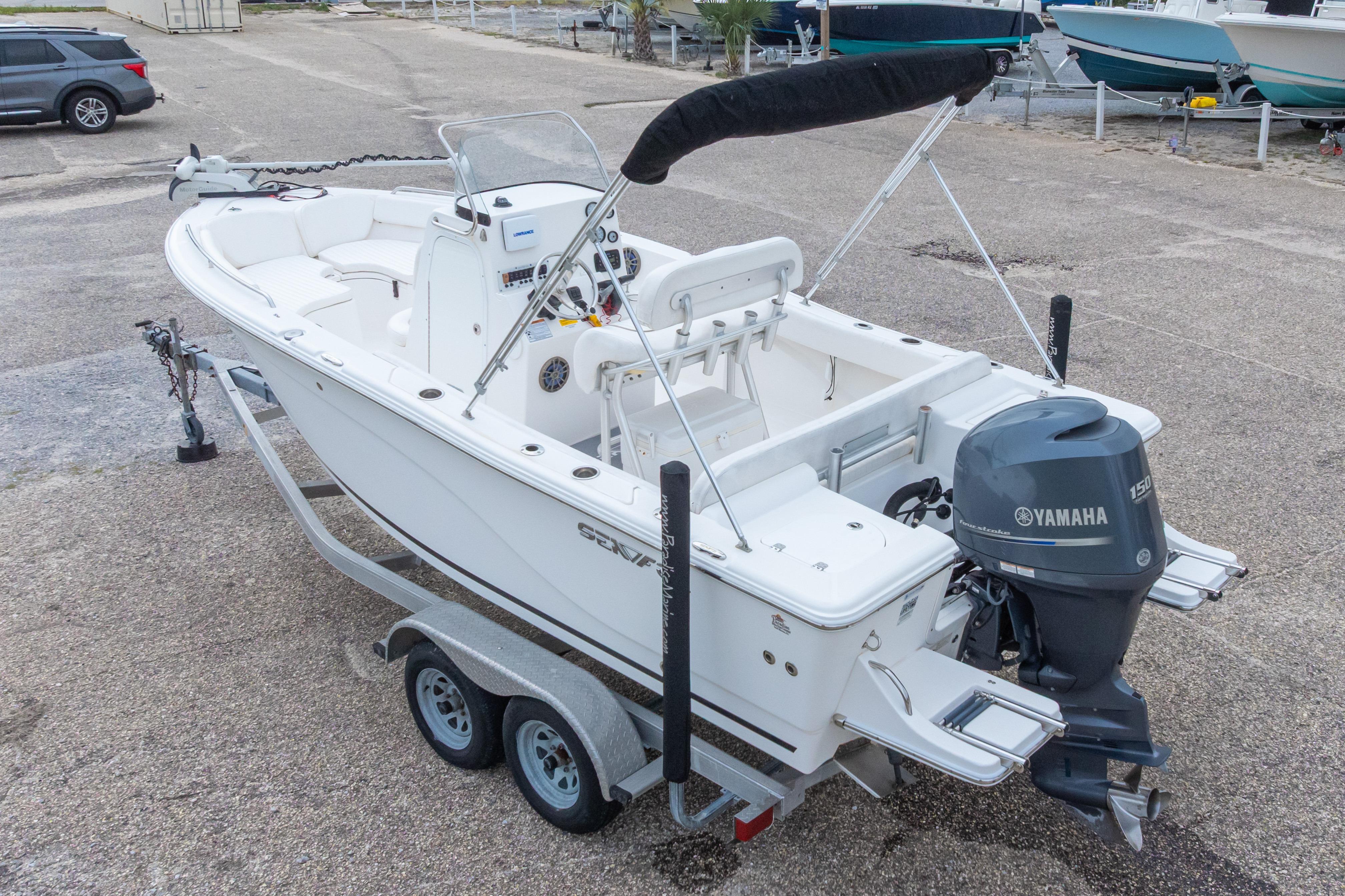 2014 Sea Fox 209 Commander boat with Yamaha engine on trailer, parked on concrete surface.