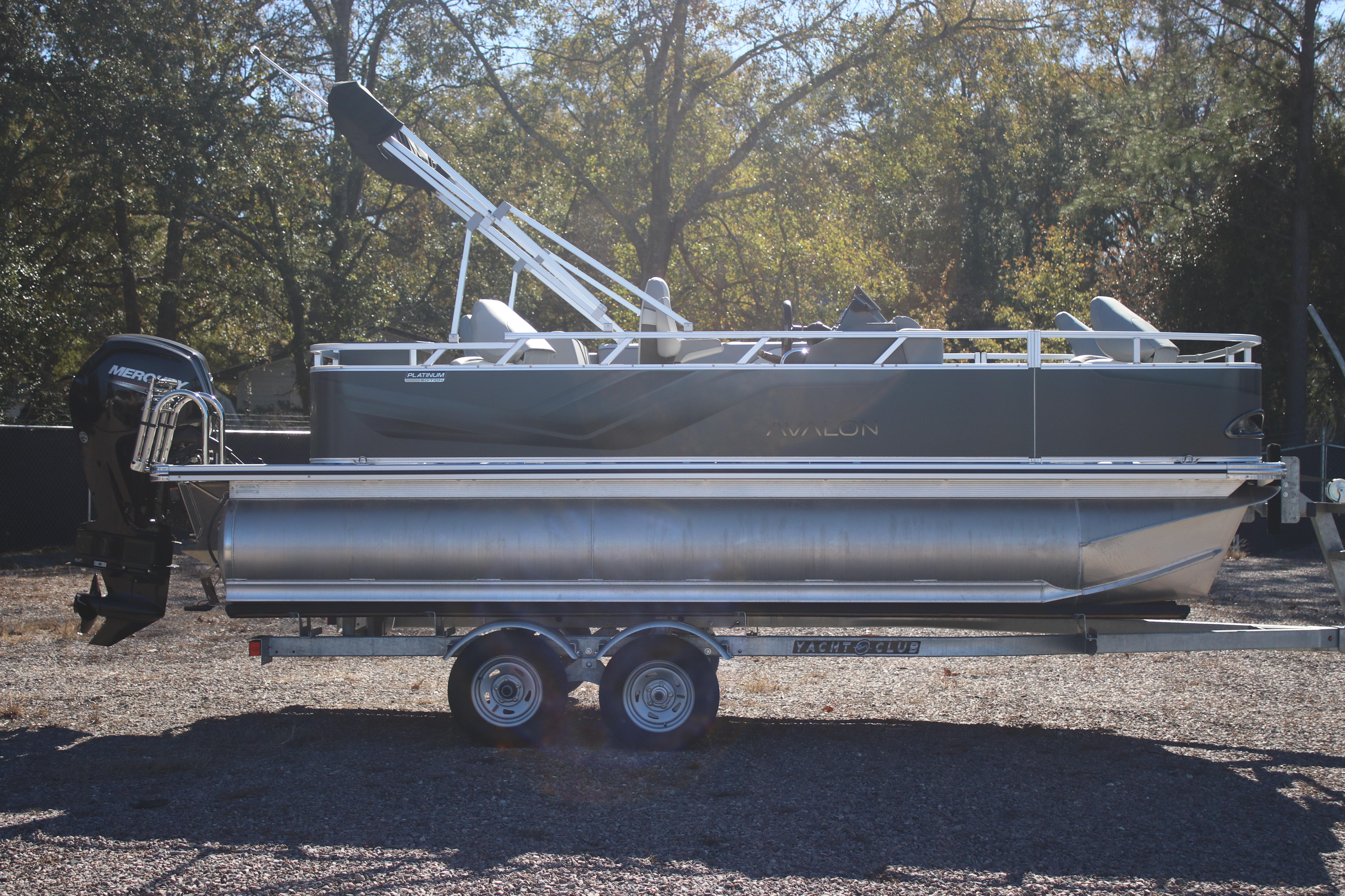 2026 Avalon VENTURE 85 QUAD pontoon boat on trailer, parked outdoors.