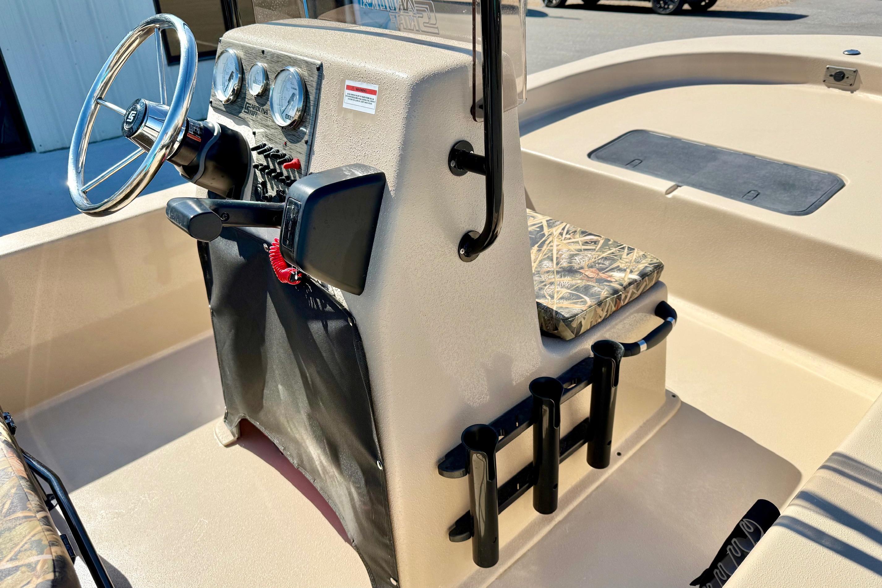 2026 Carolina Skiff E18 JVX CC boat console with steering wheel and rod holders.