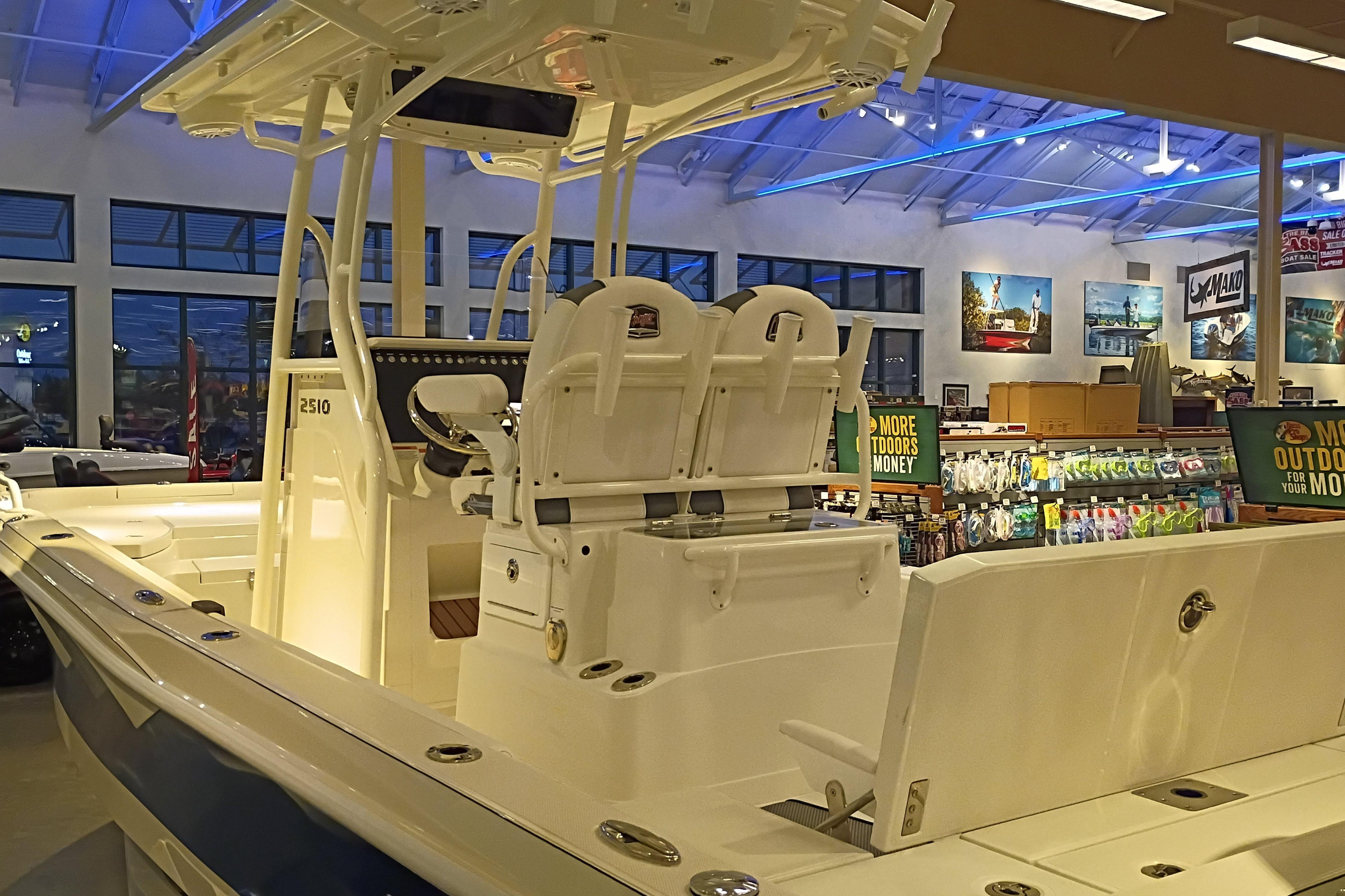 2025 Ranger 2510 Bay boat displayed in a showroom with outdoor gear.