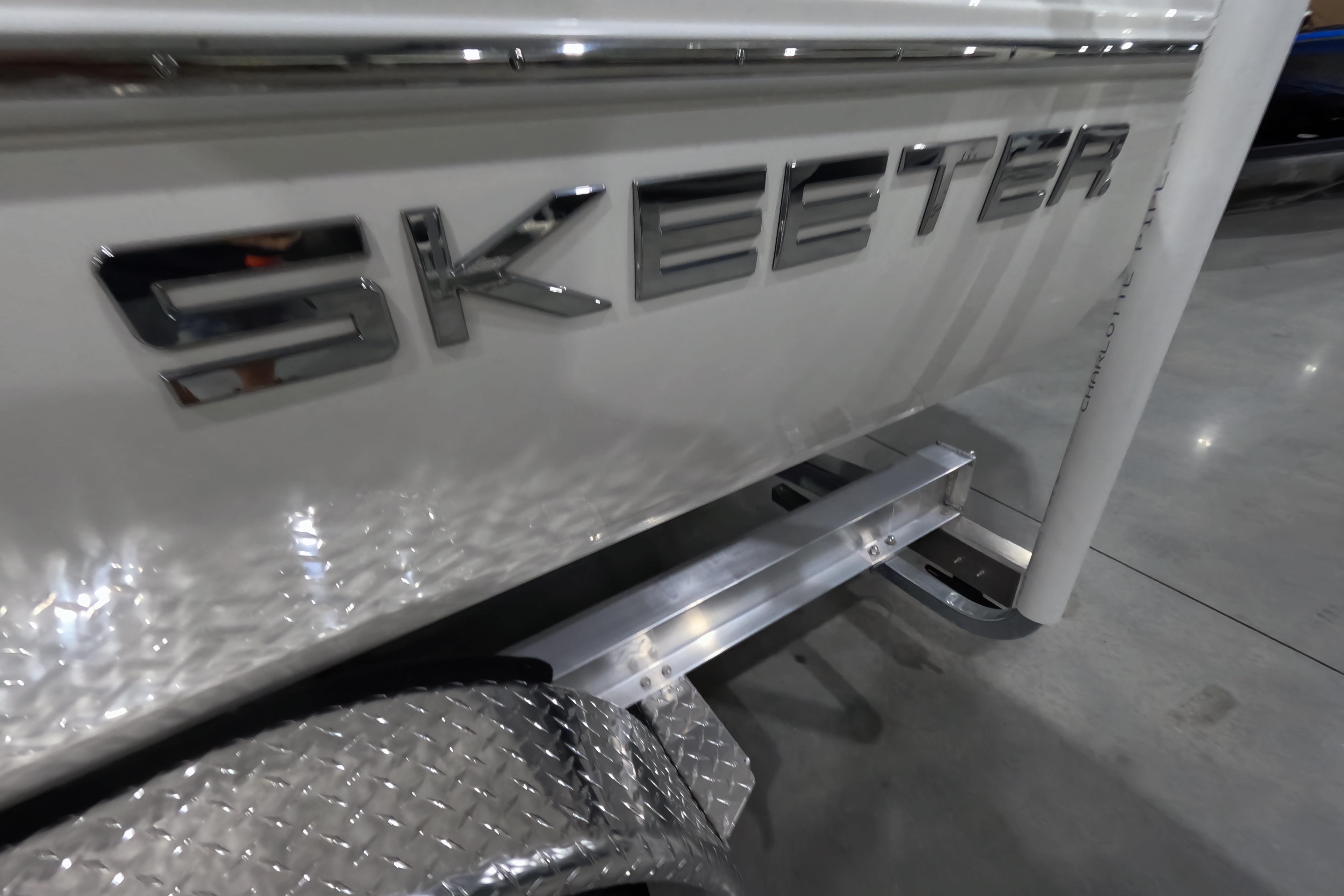 Close-up of 2026 Skeeter SX230 boat logo on a metallic surface.