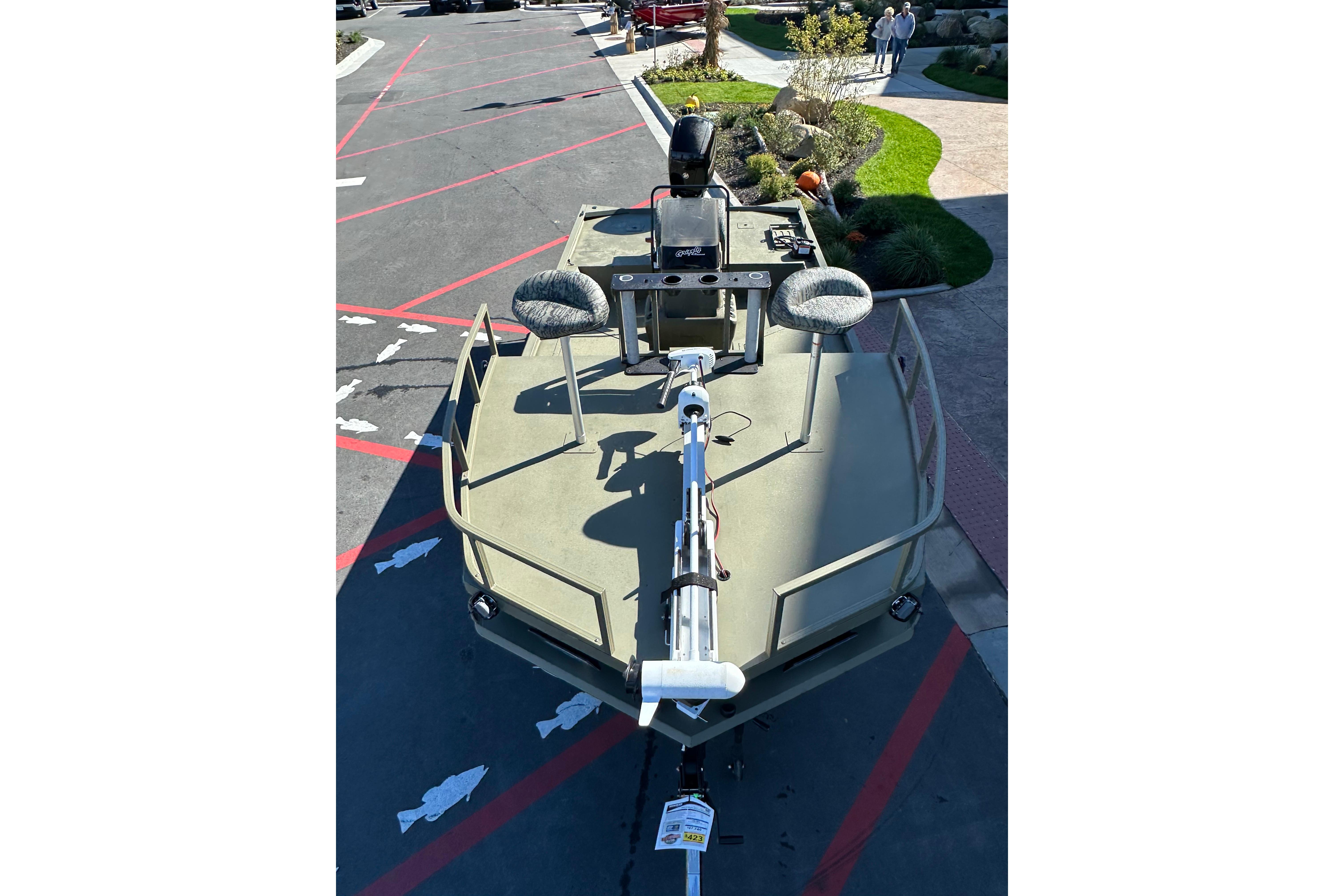 2026 Tracker Grizzly 2072 CC boat displayed outdoors, featuring dual seats and a trolling motor.