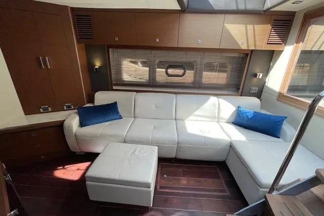 Luxurious interior of 2016 Sea Ray Sundancer 510 yacht with white leather seating and blue cushions.