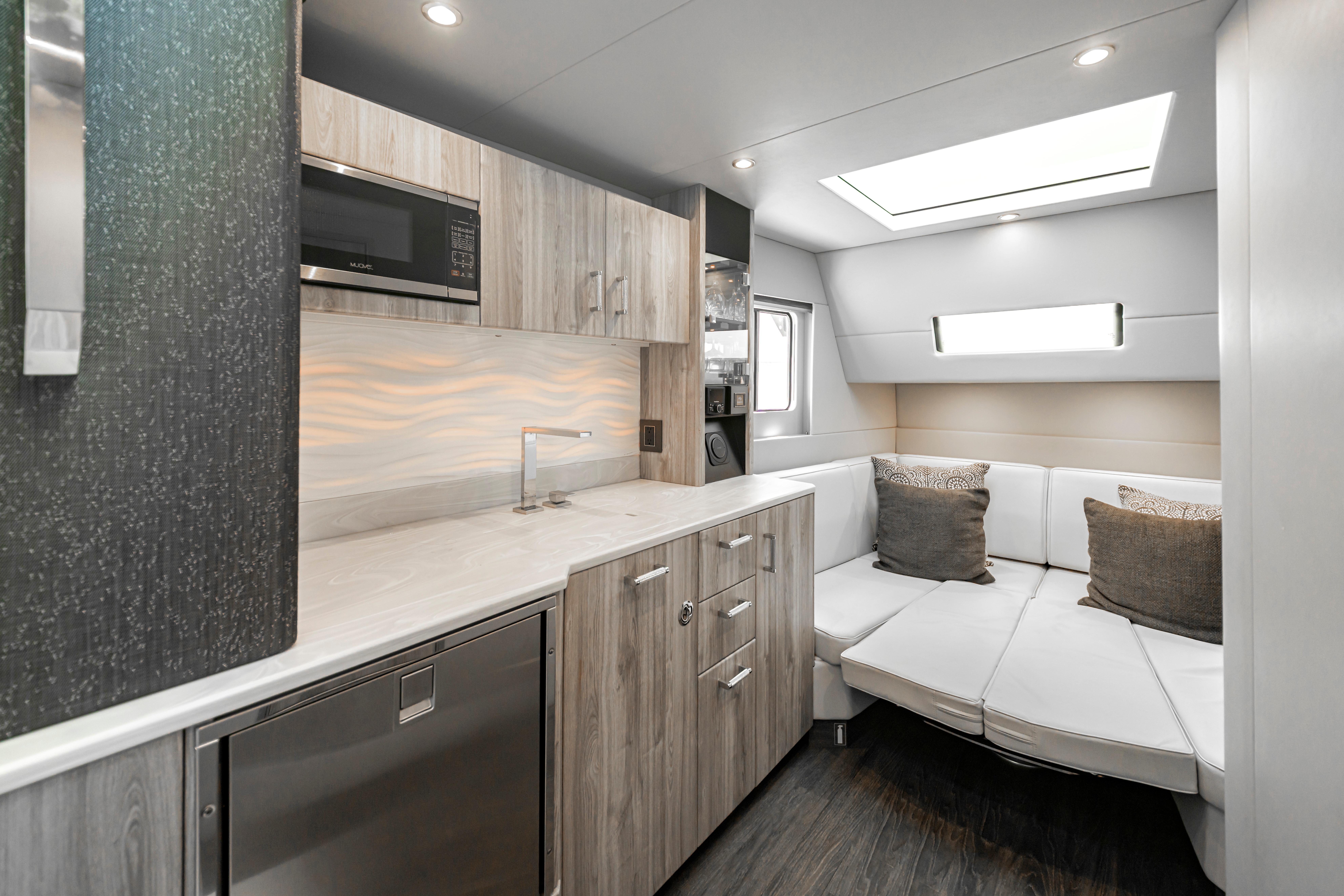 Modern interior of 2022 Formula 500 Super Sport Crossover yacht with kitchenette and seating area.