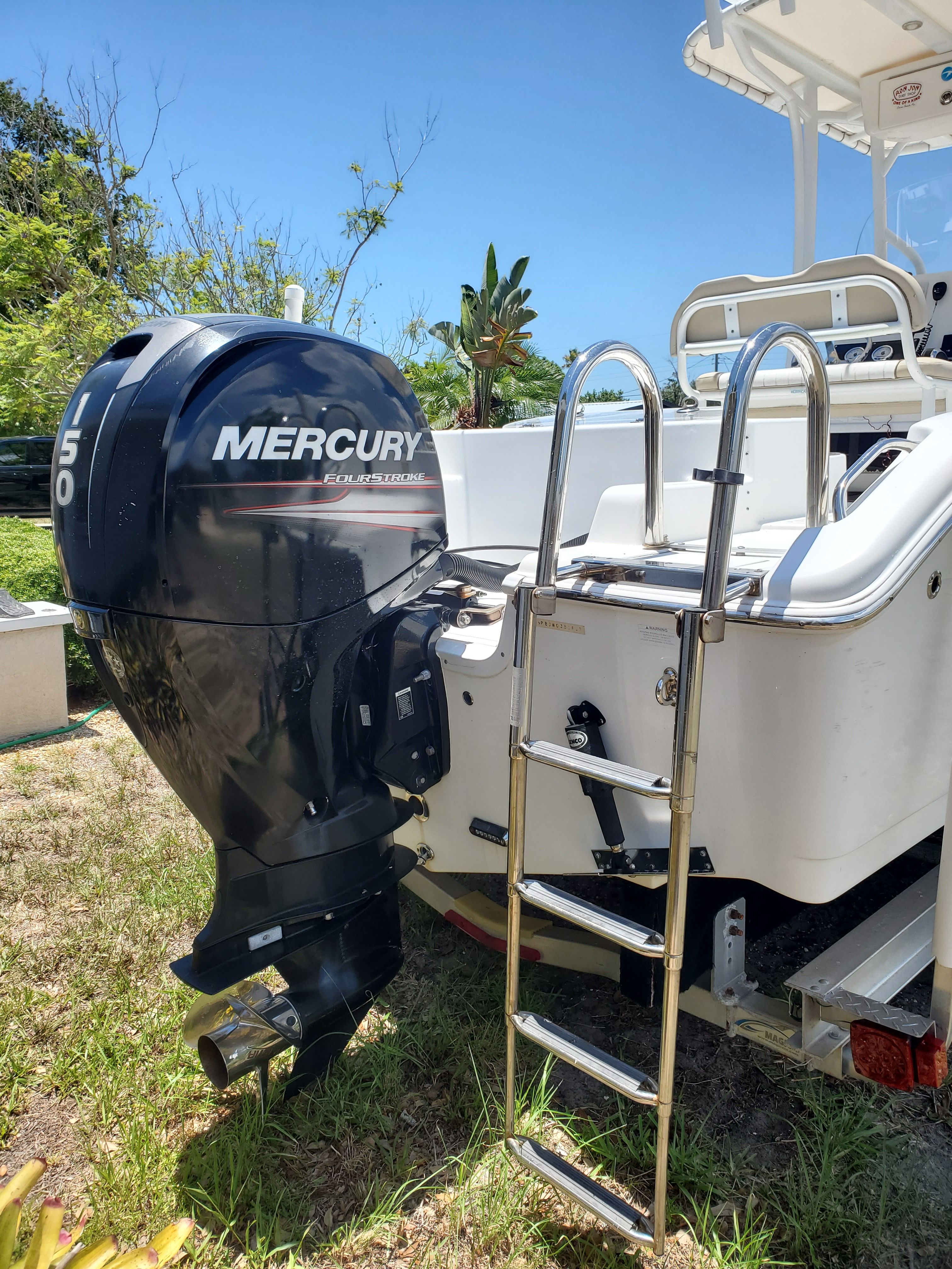 A 2017 Sea Pro 219 Center Console with a Mercury 150 outboard motor and a swim ladder.